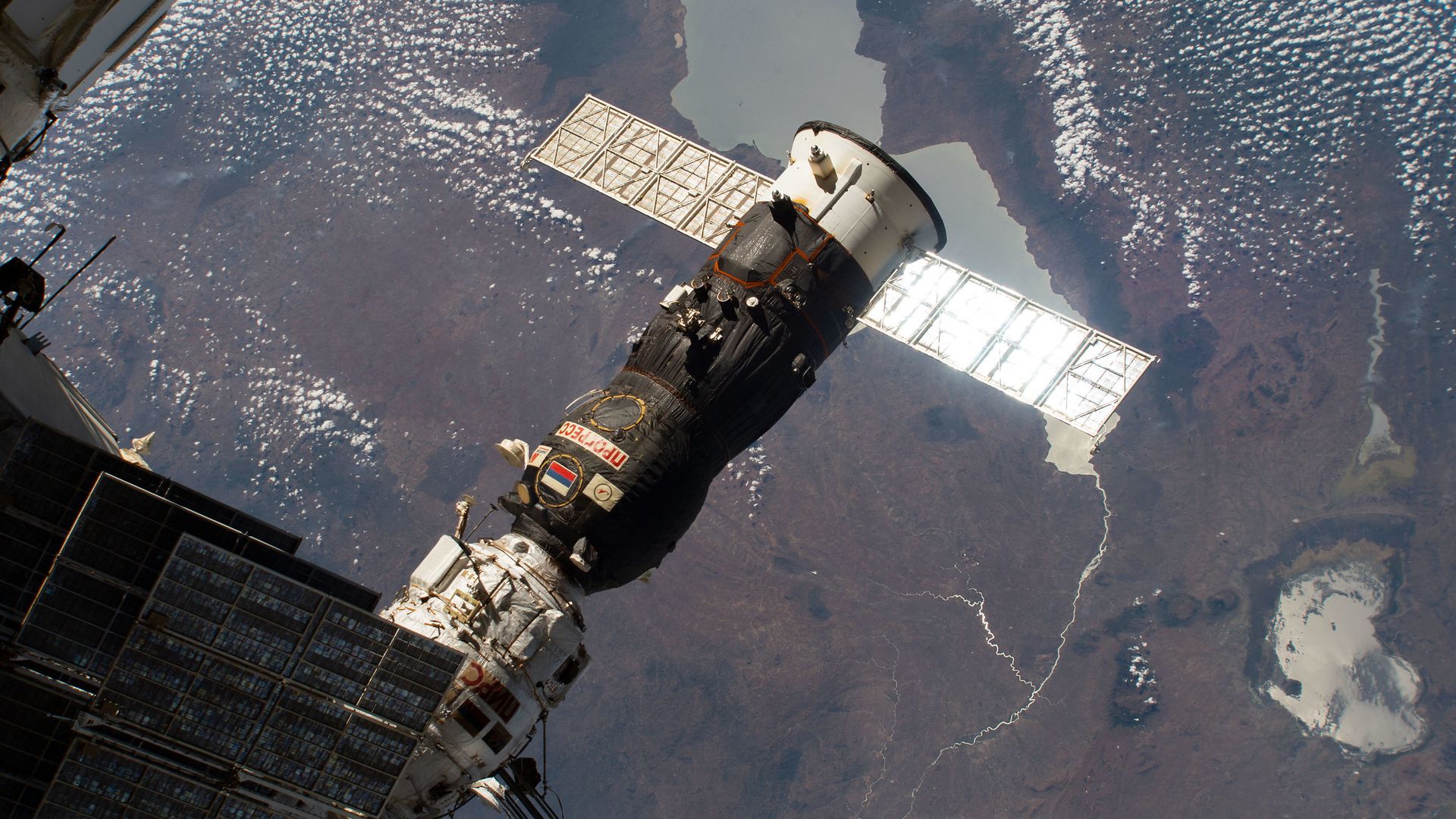 A Soyuz Progress vehicle above the Earth attached to the International Space Station