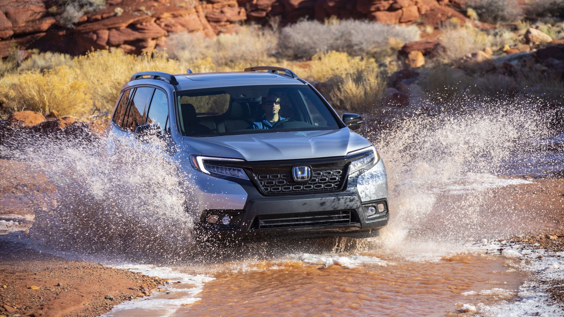 Image of Honda Passport SUV splashing through a stream