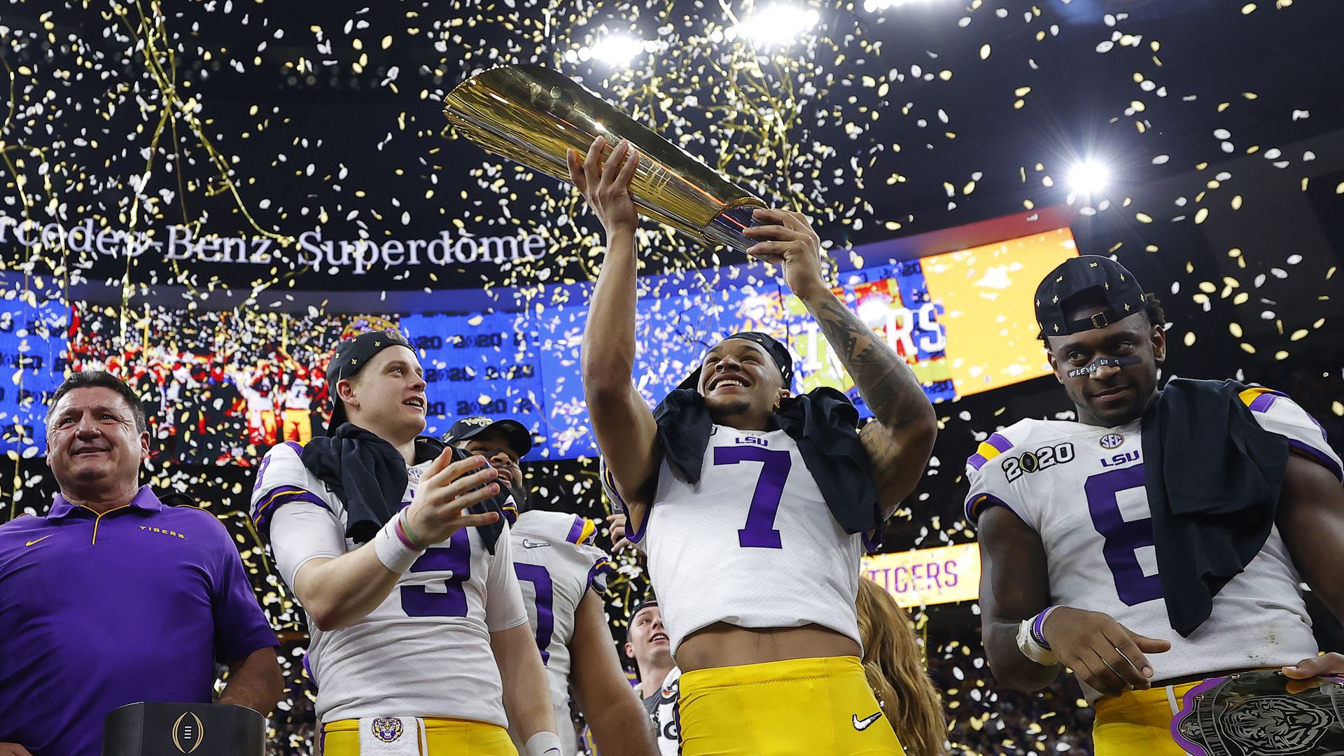  Ed Orgeron of the LSU Tigers, Joe Burrow #9 nd Grant Delpit #7  celebrate with the trophy