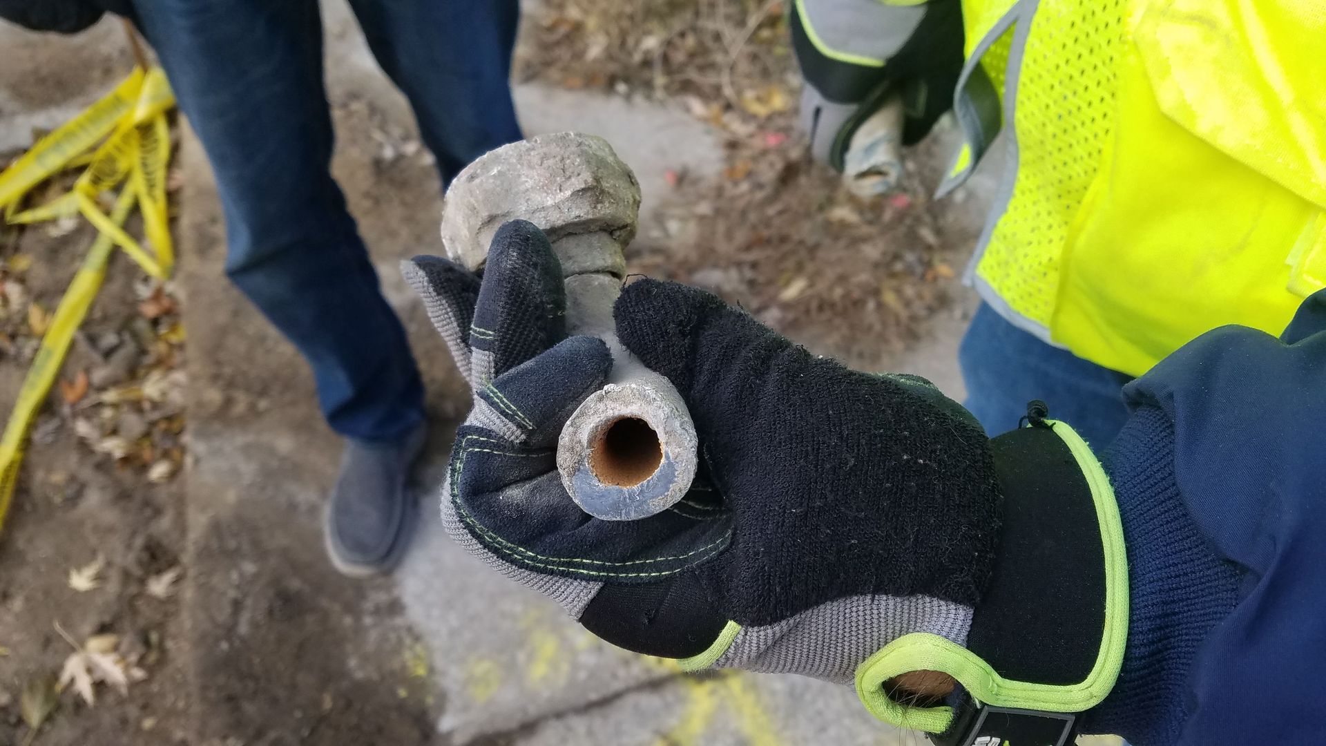 A photo of a hand holding a lead pipe. 