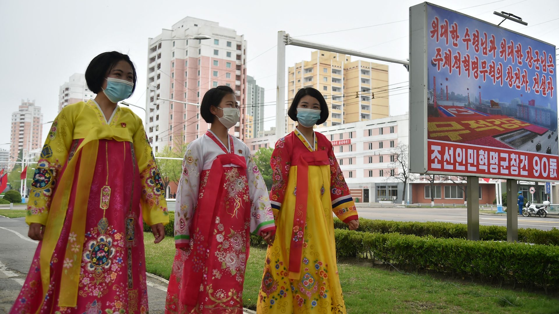 People in traditional dresses walking in Pyongyang in April 25.