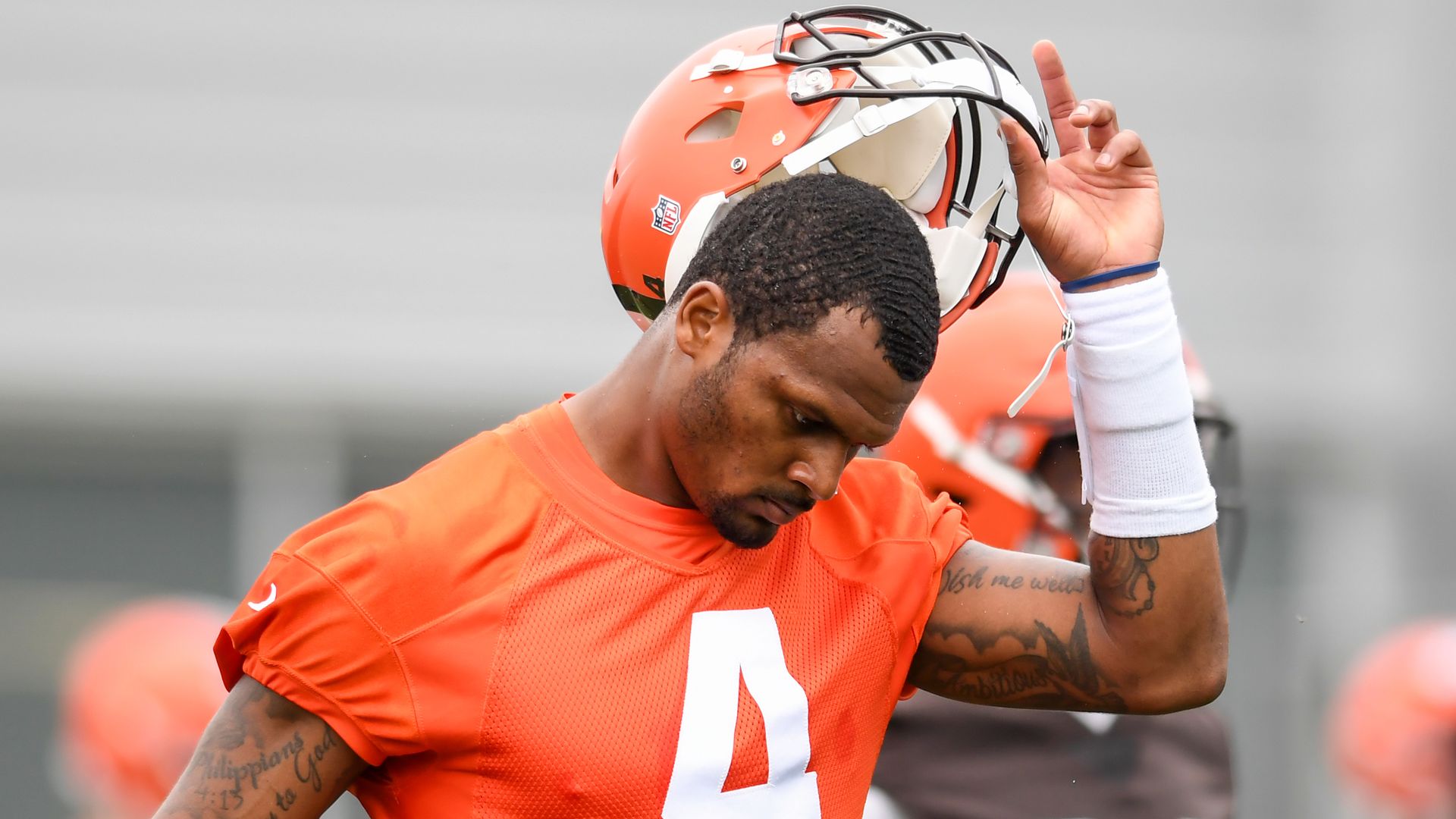 Deshaun Watson #4 of the Cleveland Browns takes off his helmet as he warms up during the Cleveland Browns.