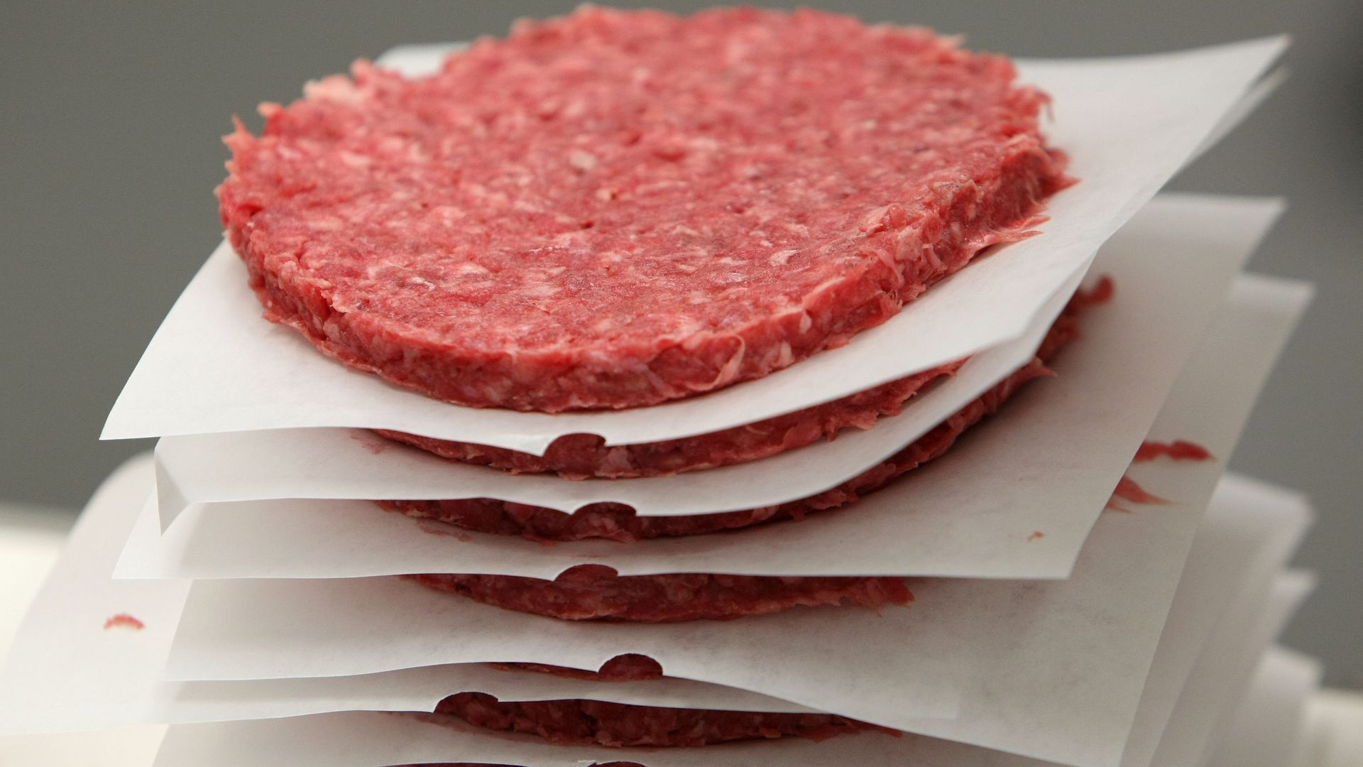 A stack of raw ground beef patties.