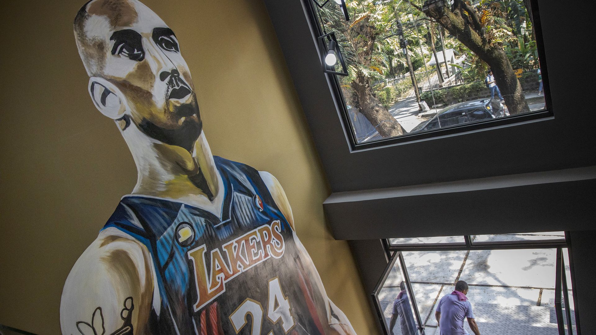 In this image Kobe Bryant is pictured in a mural on the wall in a stairwell 