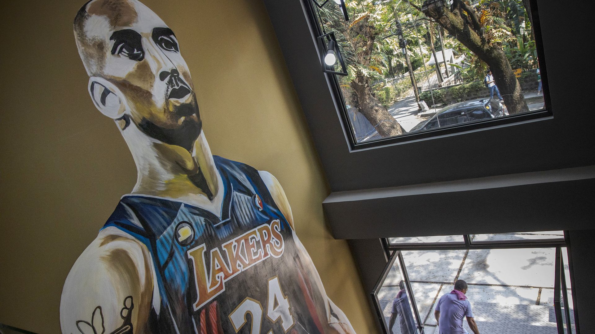 In this image Kobe Bryant is pictured in a mural on the wall in a stairwell