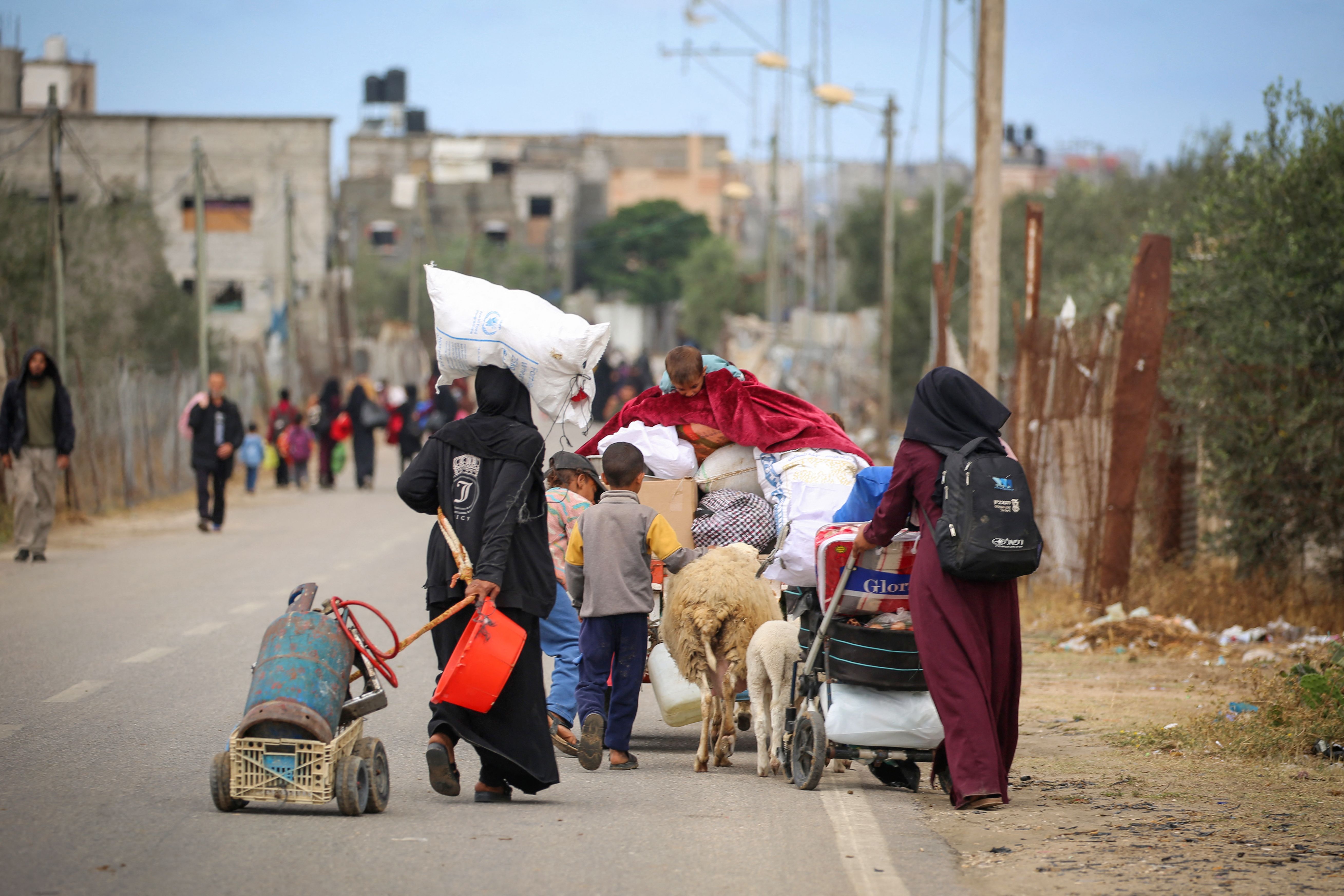 Palestinians in Rafah carry their belongings as they leave following an evacuation order by the Israeli military yesterday.