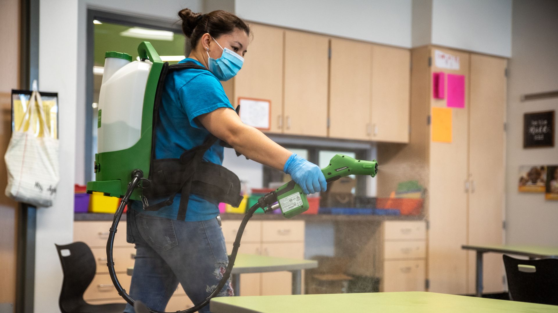 Picture of a custodial worker deep cleaning a classroom