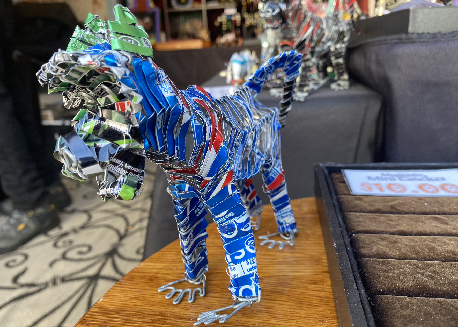A sculpture of an animal made of aluminum cans.