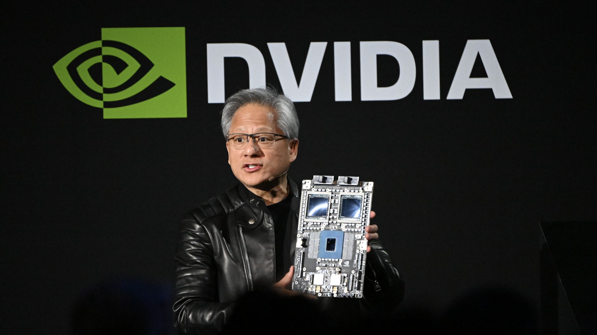 Nvidia CEO Jensen Huang holding one of the company's AI chips.
