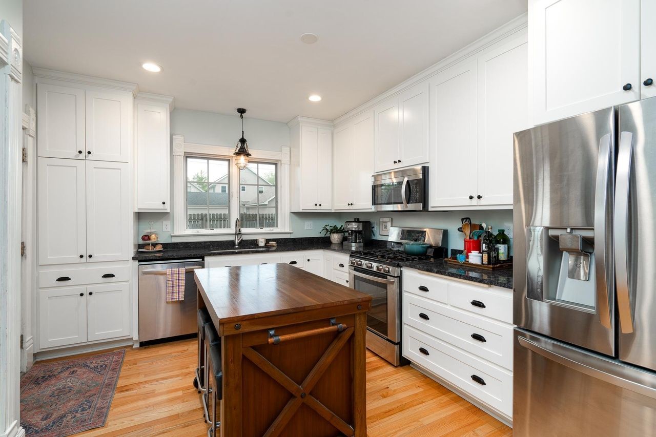 kitchen with white cabinets and a wooden island