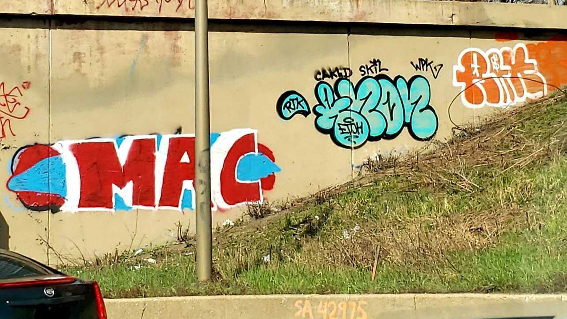 Photo of graffiti on highway overpass. 