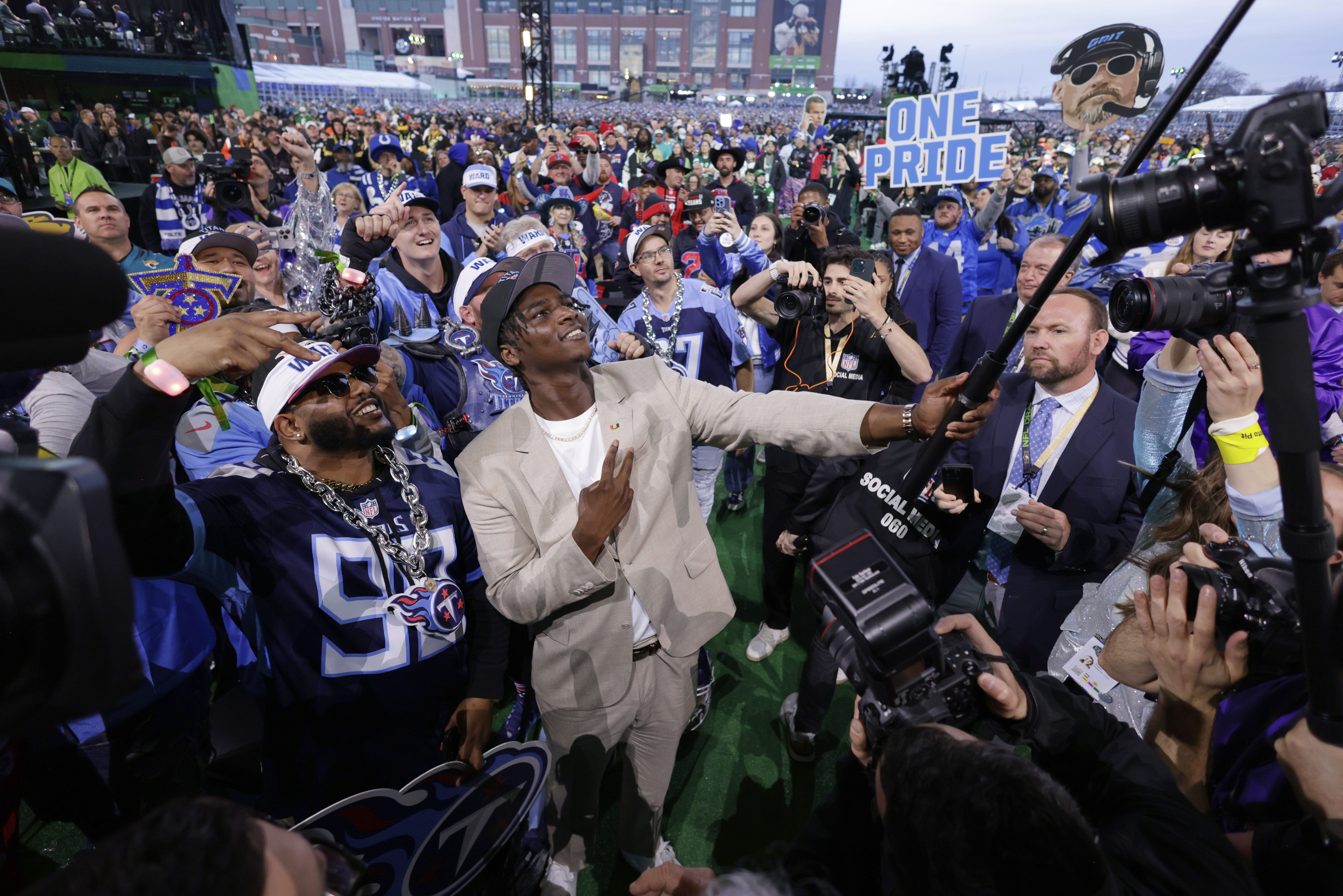 Miami quarterback Cam Ward takes a selfie with fans after being chosen by the Tennessee Titans with the first overall pick during the first round of the NFL football draft, Thursday, April 24, 2025, in Green Bay, Wis. (AP Photo/Matt Ludtke)
