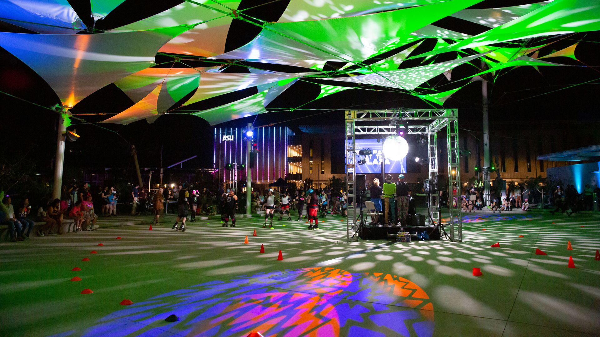 A park at night with lights and a geometric overhang.