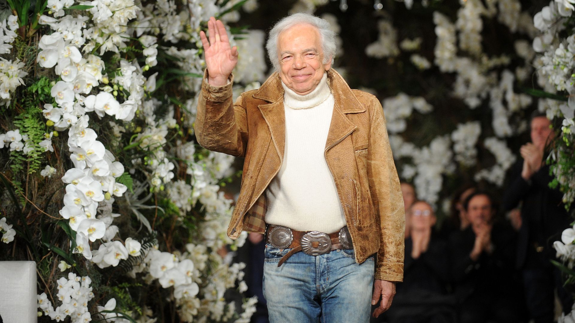 Ralph Lauren waves to the audience at the end of a fashion show. Photo: Desiree Navarro/WireImage