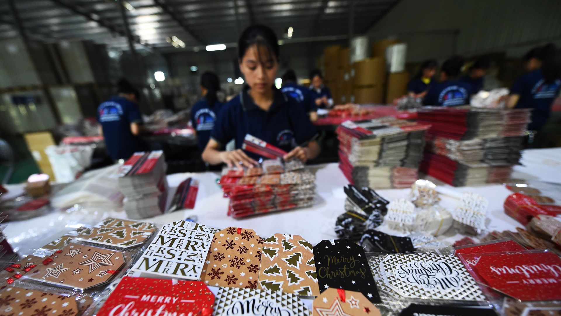 A woman works arranging Christmas cards