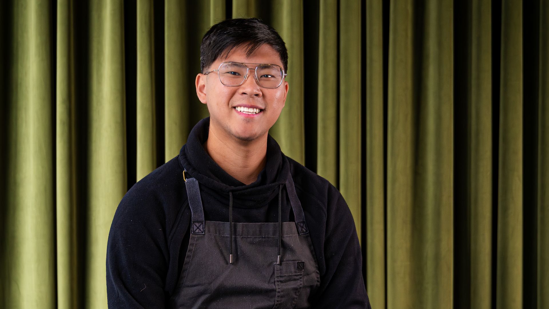Chef Kevin Tien against a green backdrop curtain
