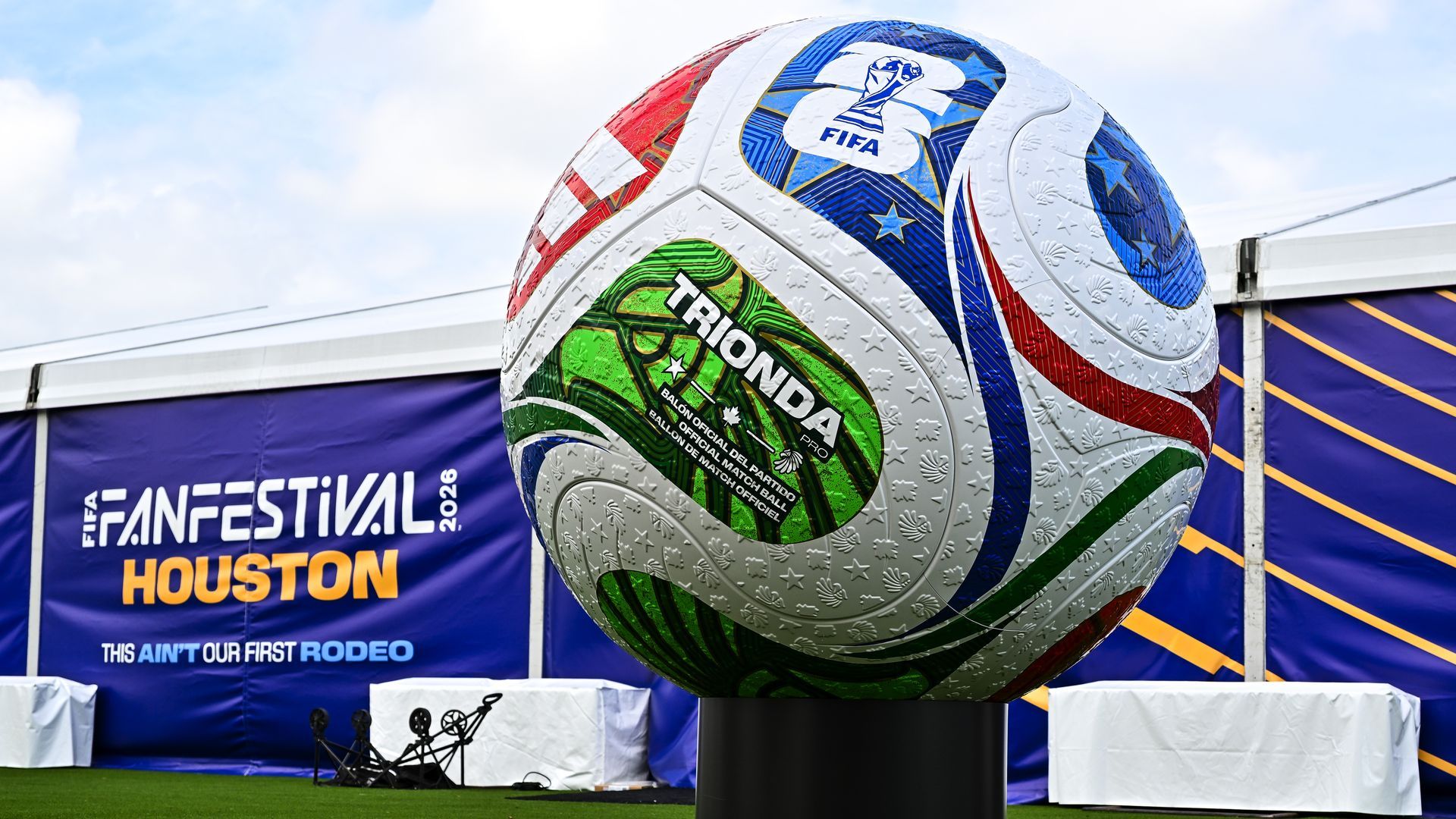 A massive soccer ball with green, blue and red lines on it