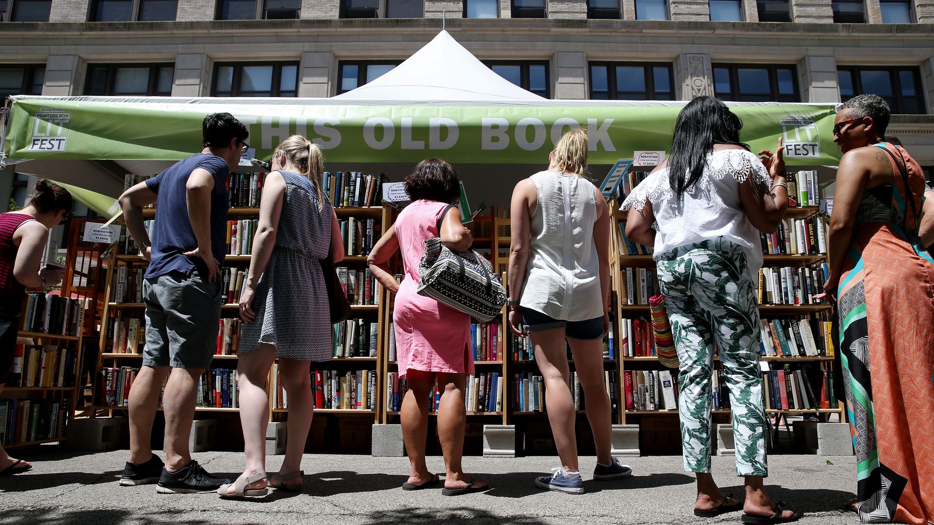 Attendees of the Printer's Row Lit Fest in Chicago looking at shelves of books 