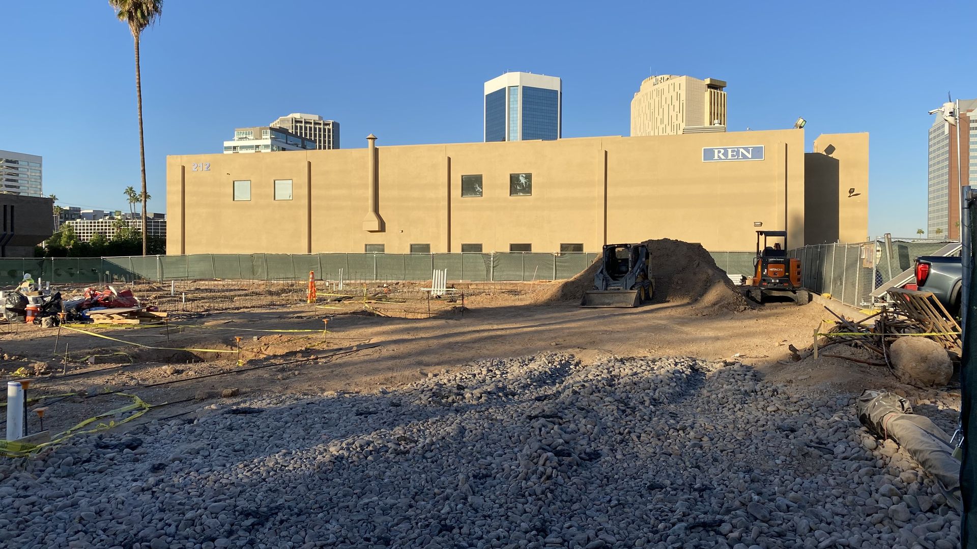 A construction site with skyscrapers in the background.