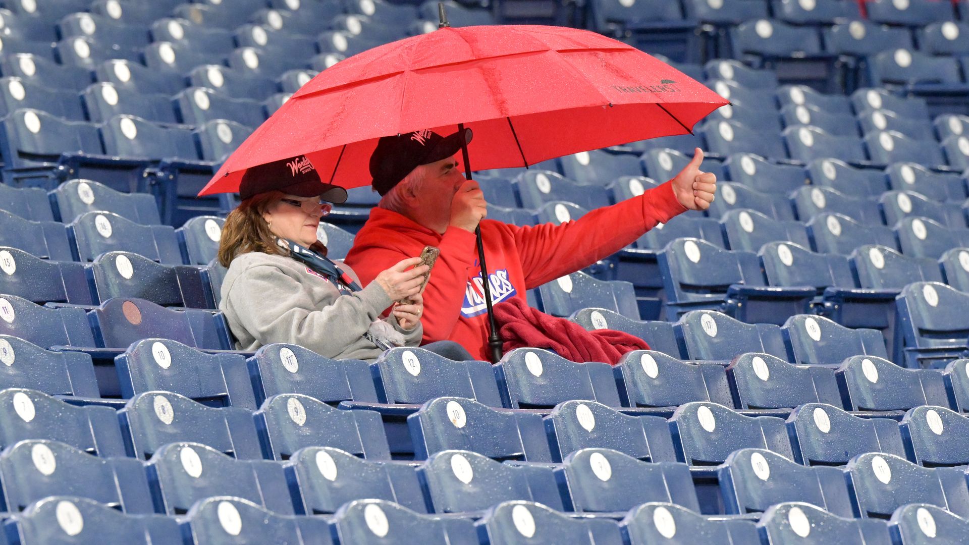 Phillies fans under an umbrella