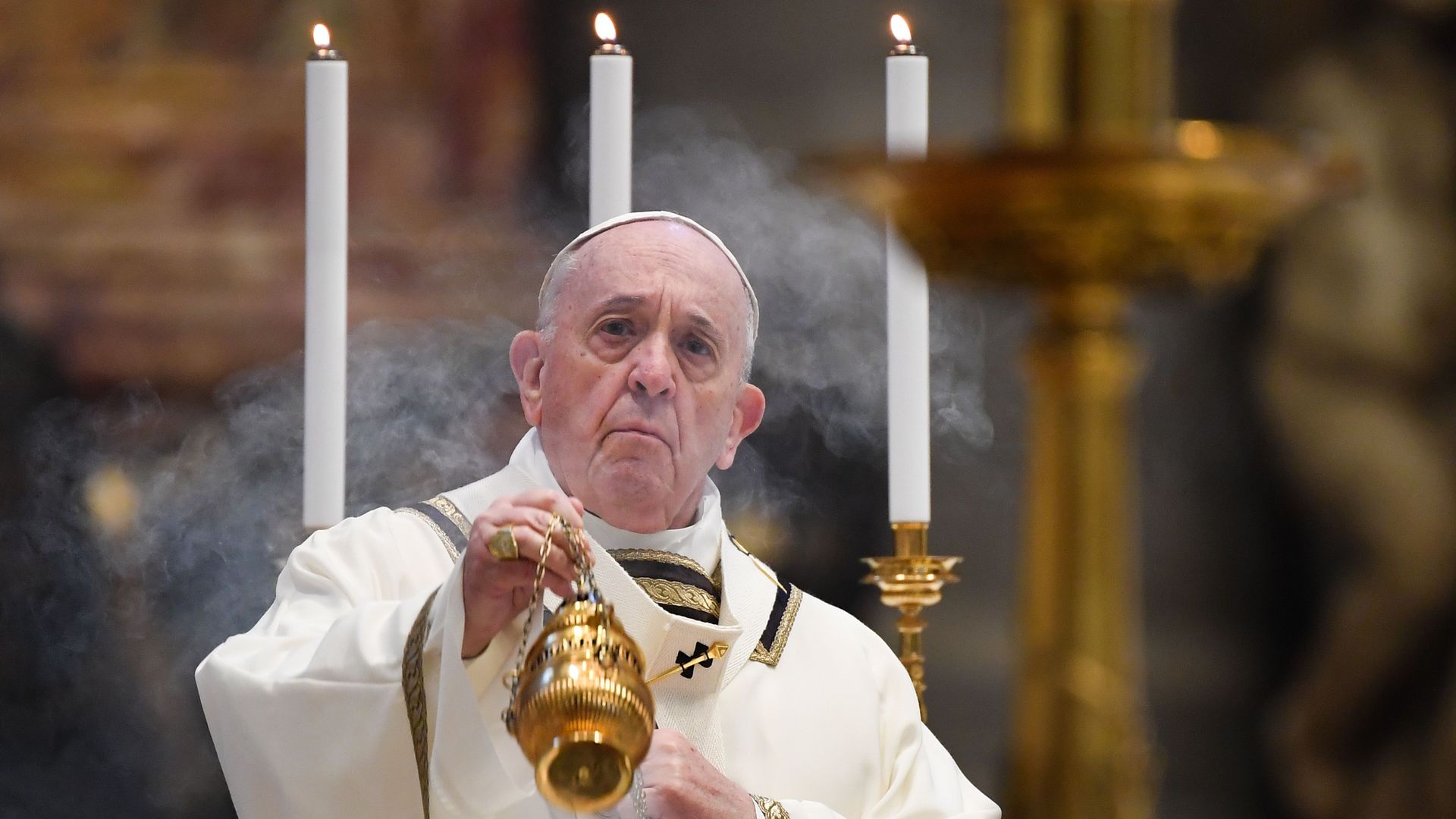Pope Francis swings a thurible at the start of Easter Sunday Mass on April 12