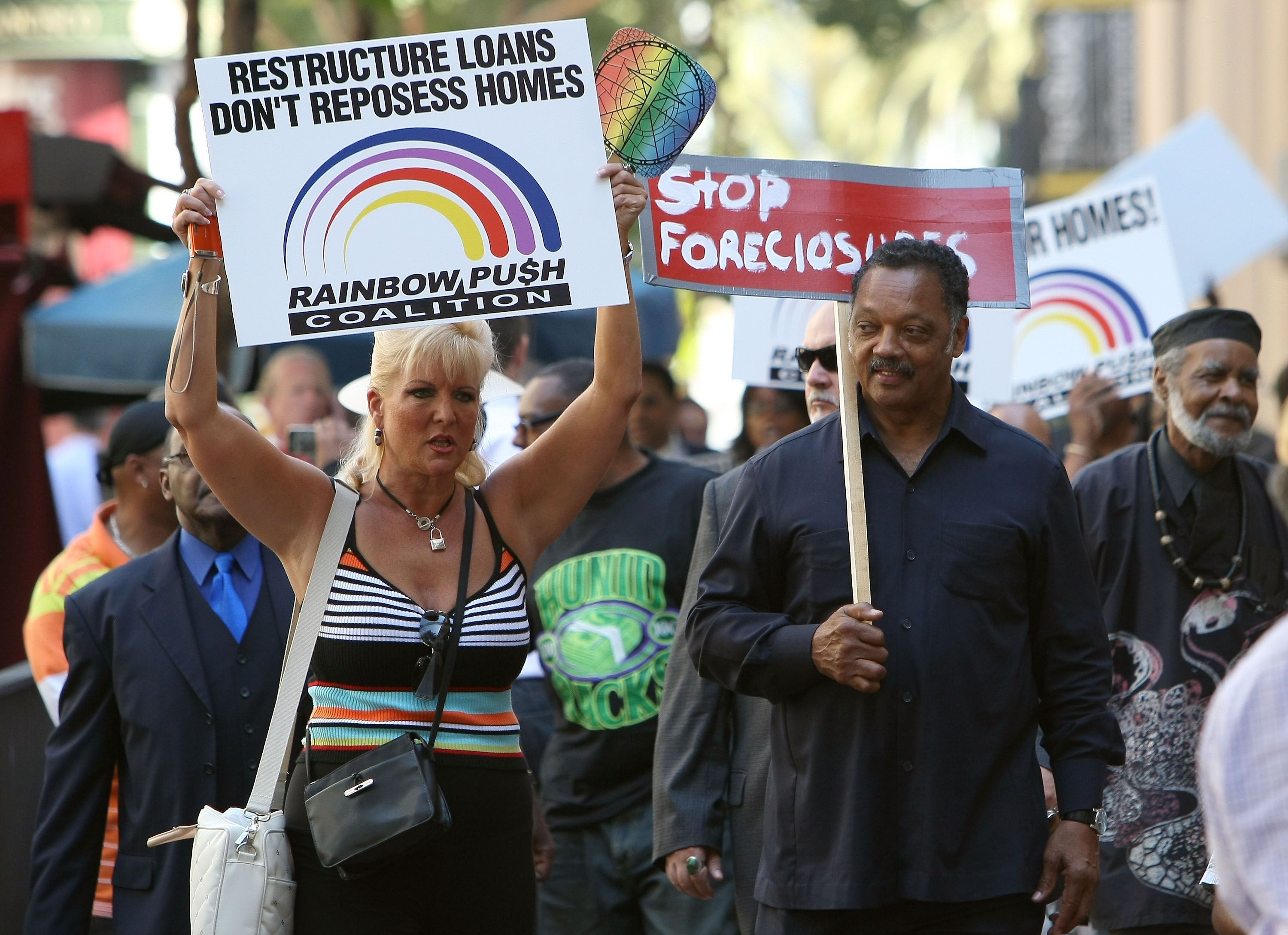 SAN FRANCISCO - SEPTEMBER 18: Rev. Jesse Jackson (R) carries a sign during a demonstration against home foreclosures in front of the Federal Reserve Bank September 18, 2009 in San Francisco, California. Rev. Jesse Jackson led dozens of people in a protest and prayer against home foreclosures asking