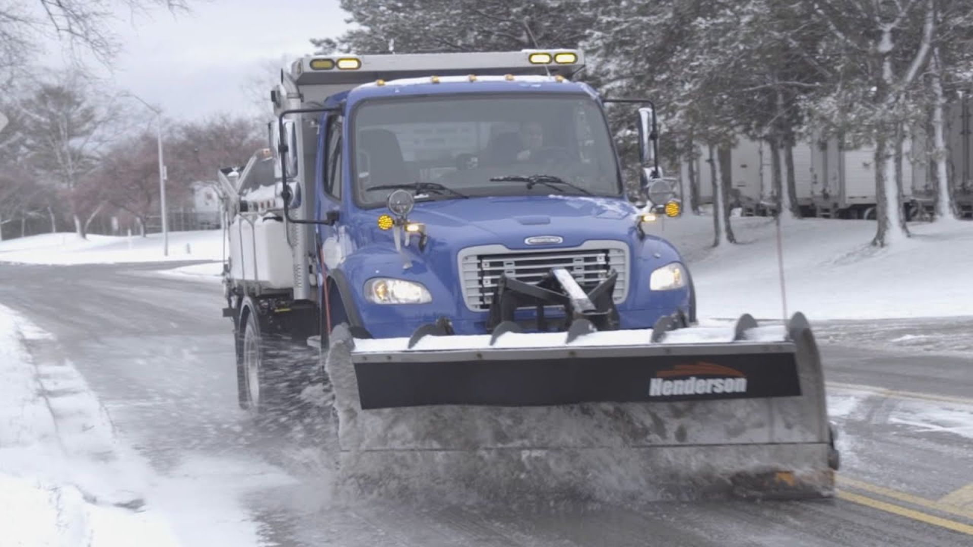 A blue snow plow on a city of Hilliard street