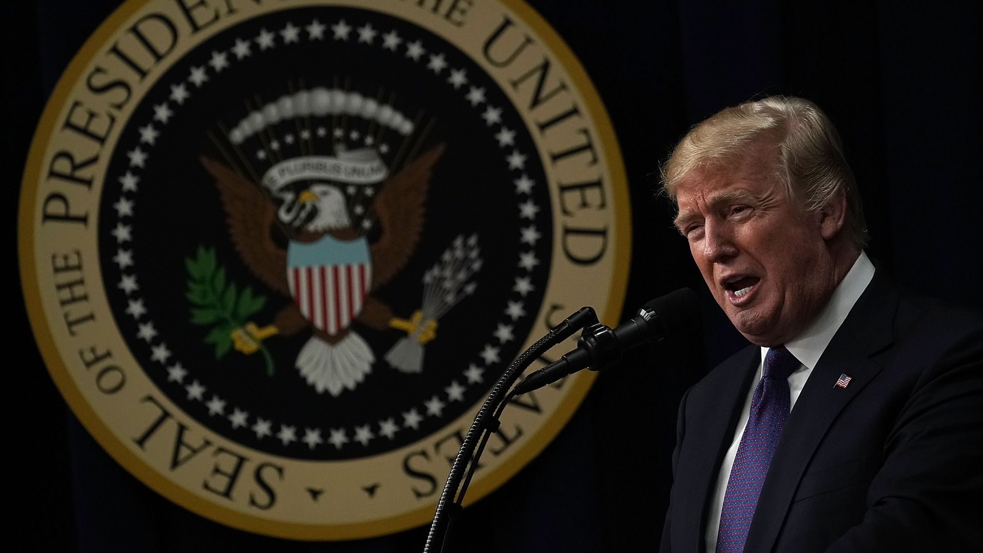 President Trump speaking into a microphone