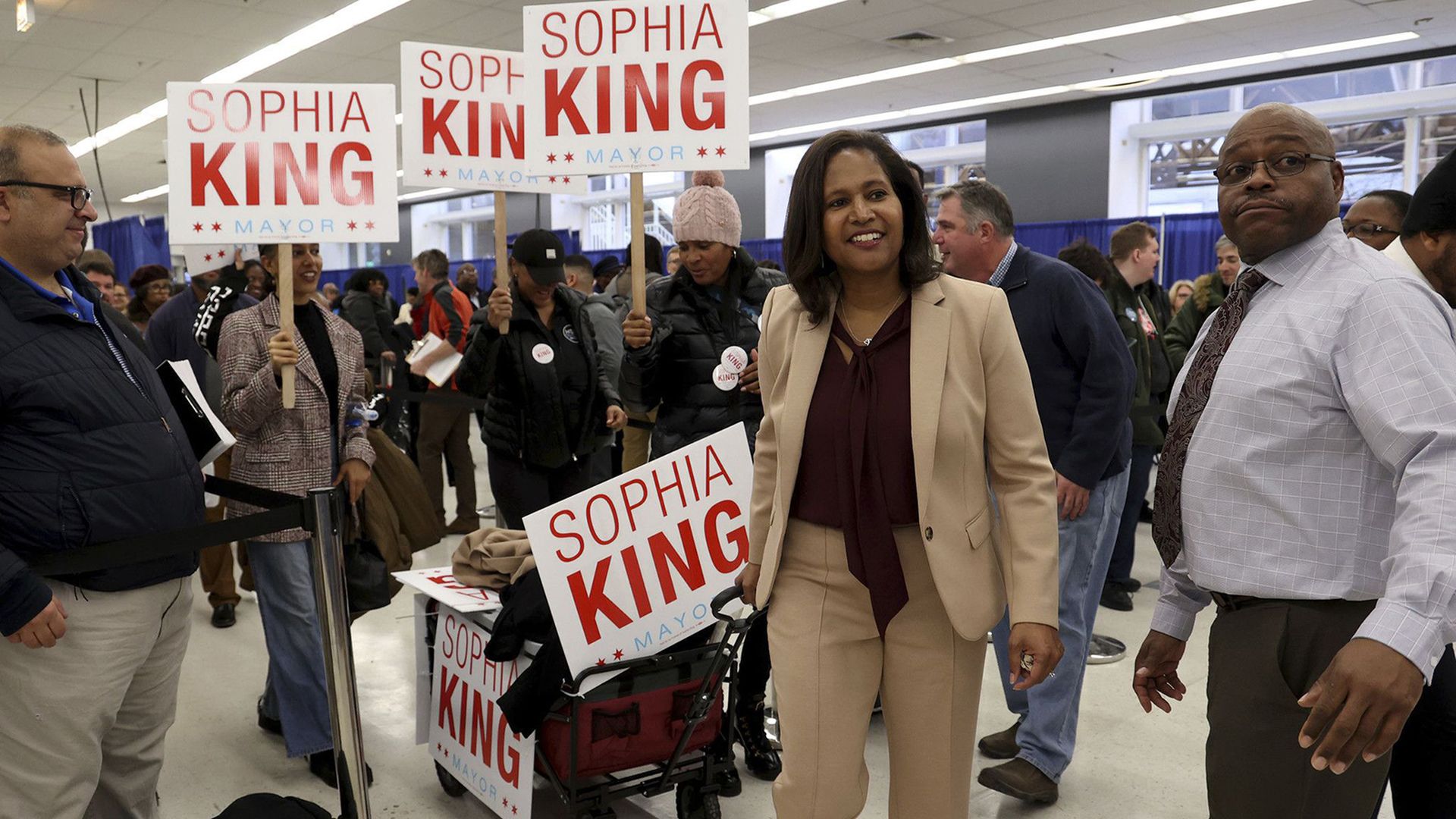 Politician in front of signs