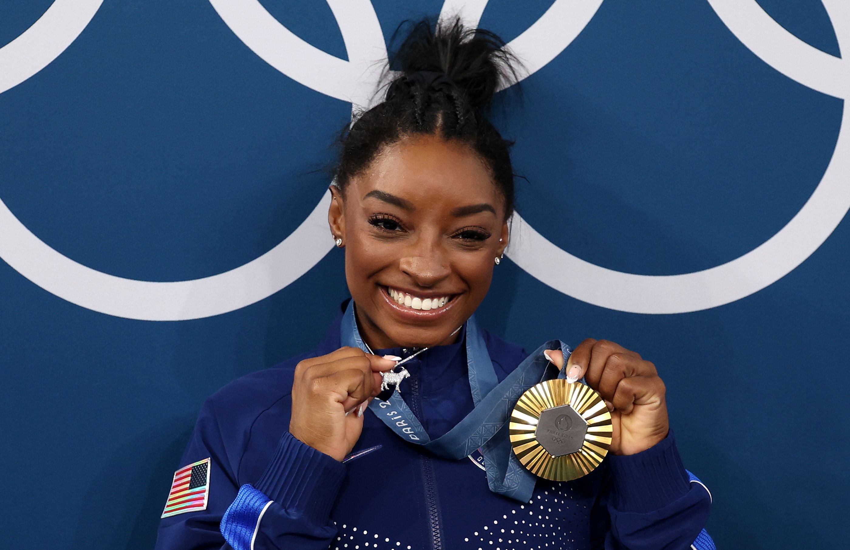 Simone Biles with GOAT necklace and gold medal