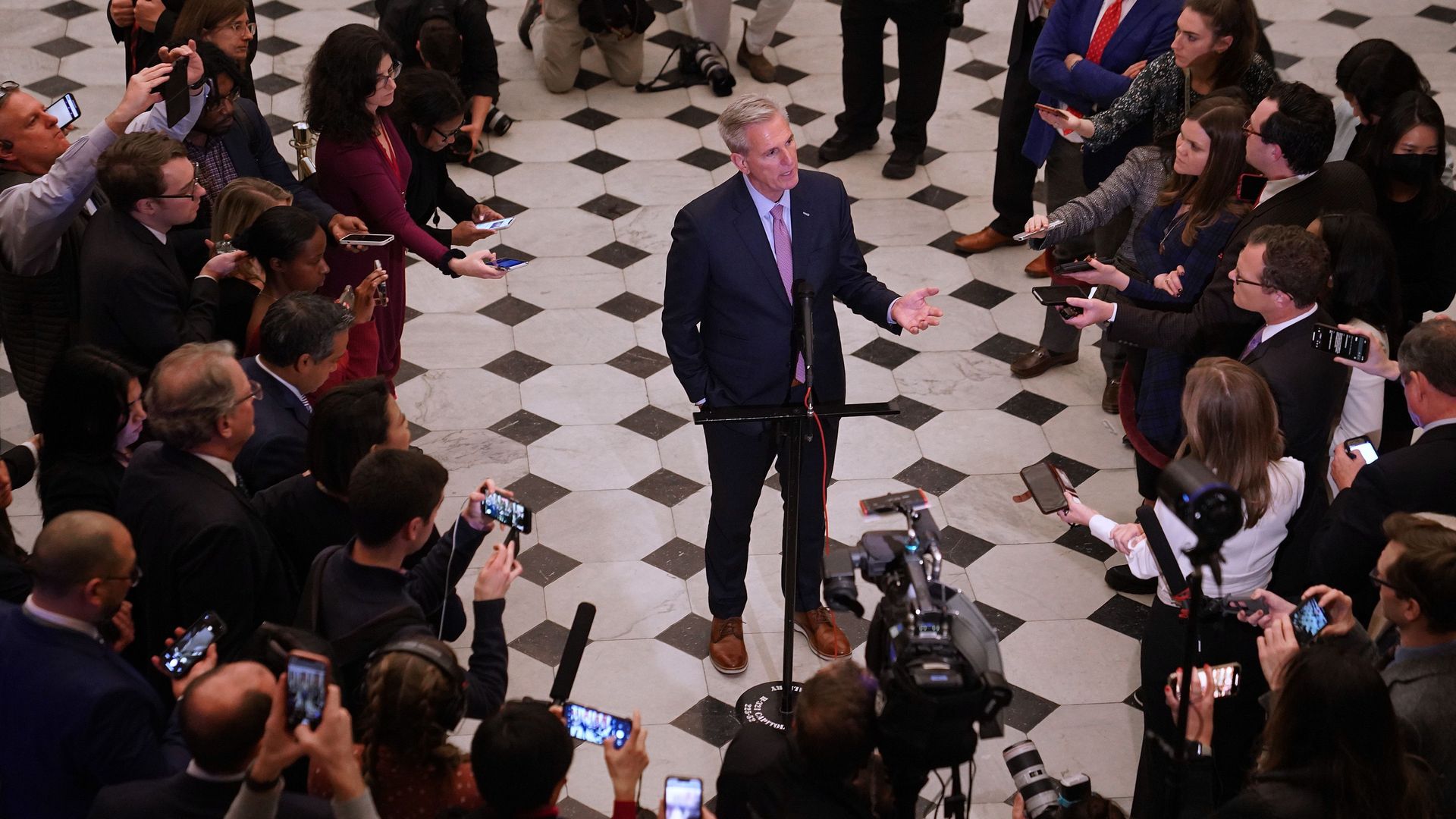 Speaker McCarthy meets reporters in Statuary Hall early Saturday after being sworn in.