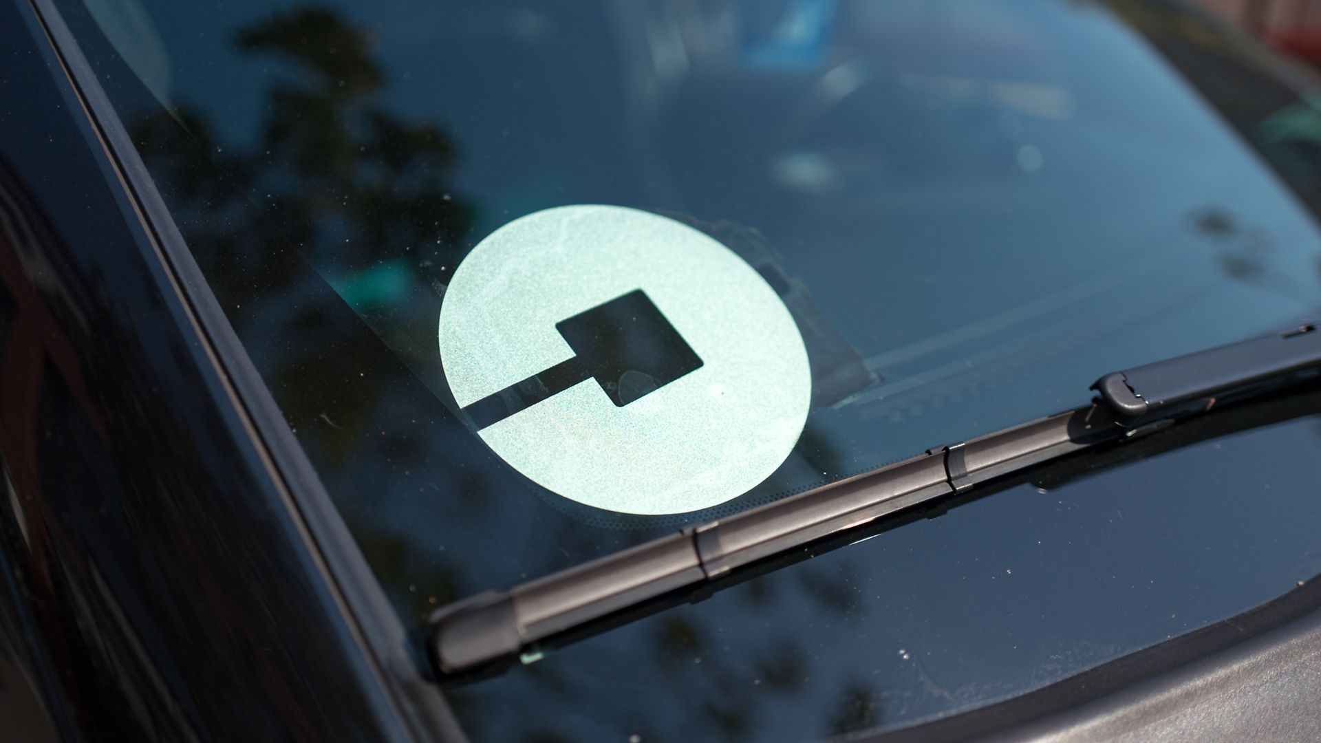 Car windshield with Uber logo. 
