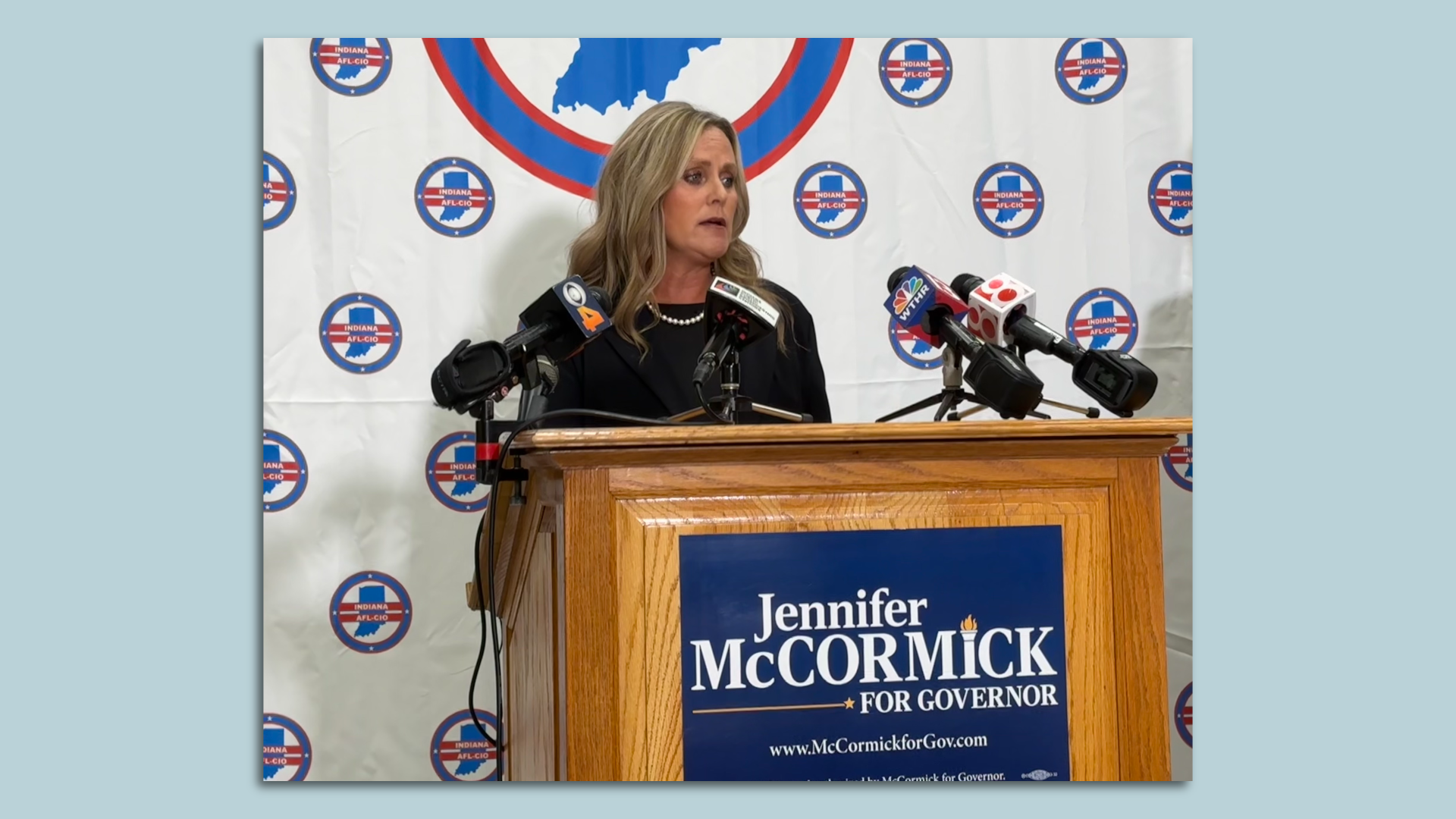 Jennifer McCormick standing at a podium