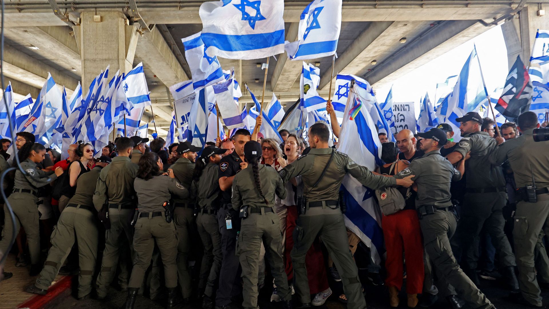  Israeli security forces block anti-government demonstrators during a rally at Ben Gurion Airport near Lod on July 11, 2023. 