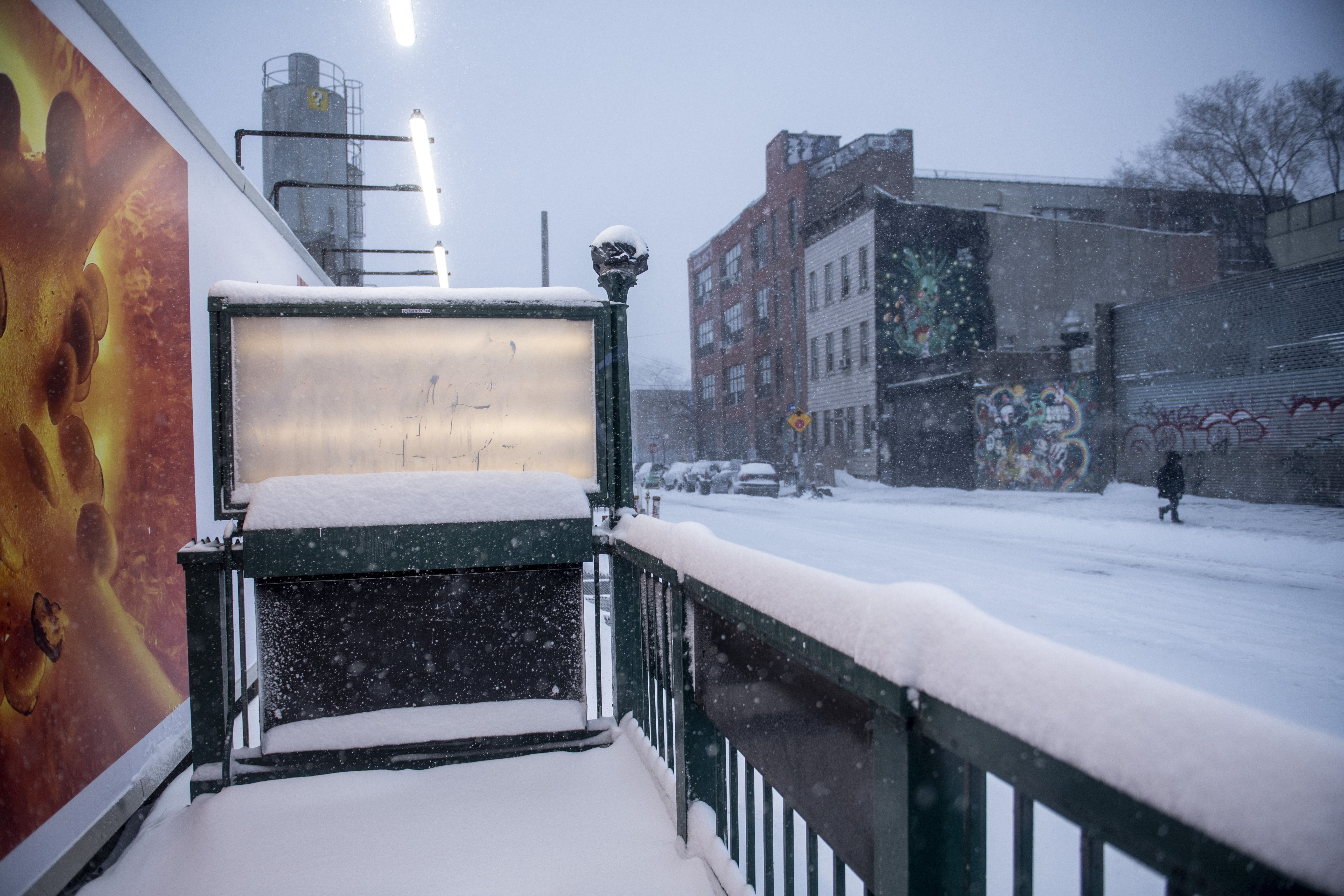 Snow covers the entrance of the subway station in the Bushwick section of the Brooklyn borough of New York on Saturday, Jan. 29, 2022.