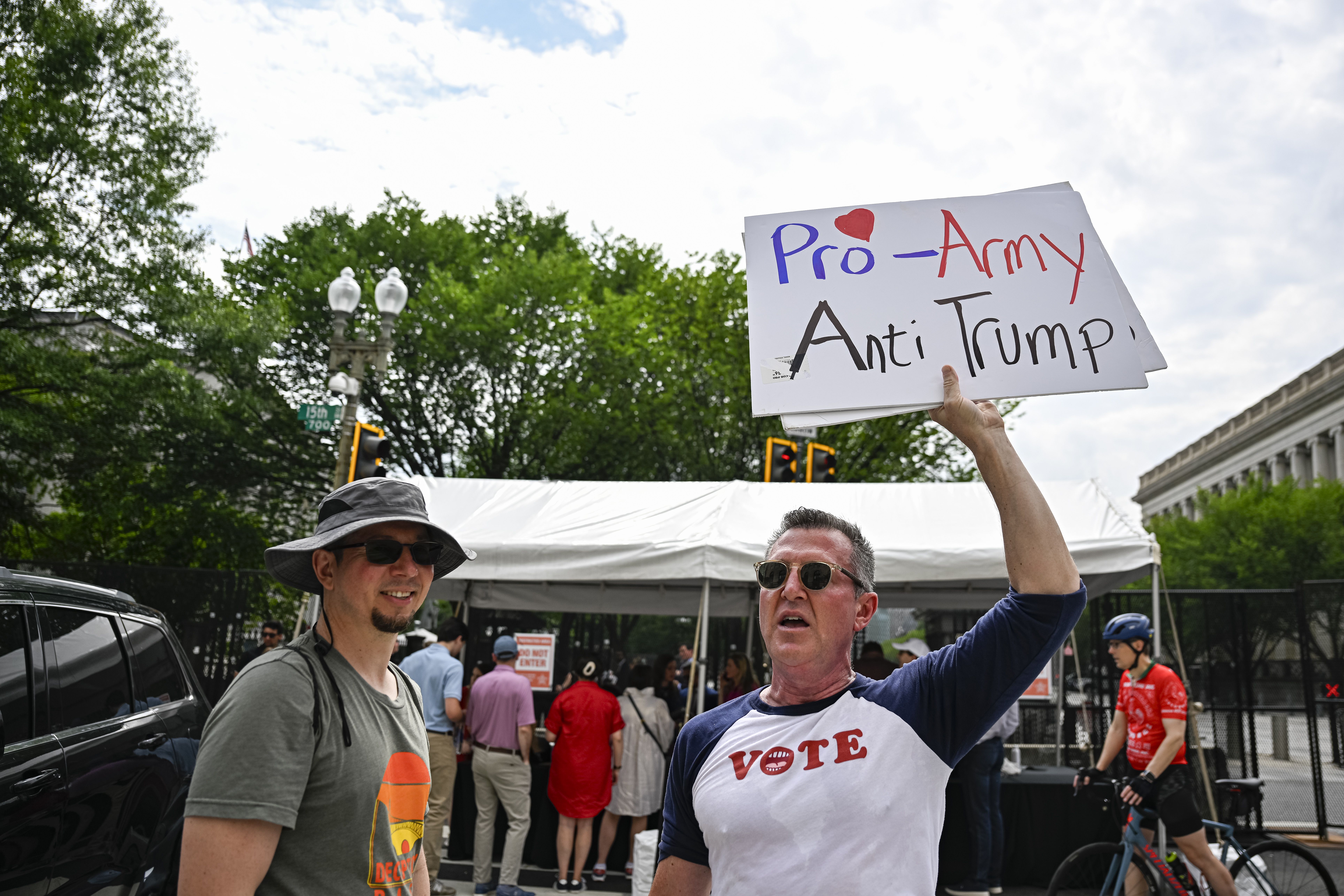 A protester holds up a sign that says "Pro-Army Anti-Trump" outside the White House.