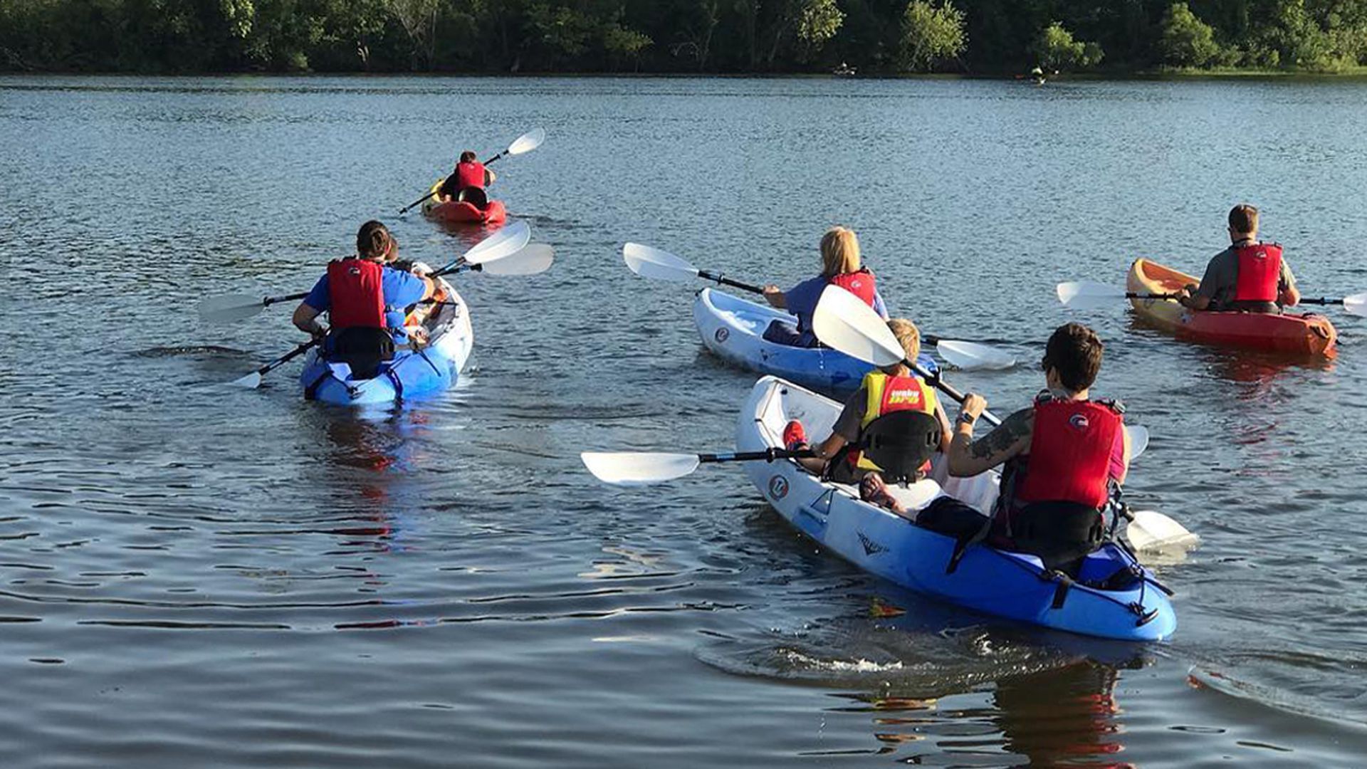 People canoeing on a river.