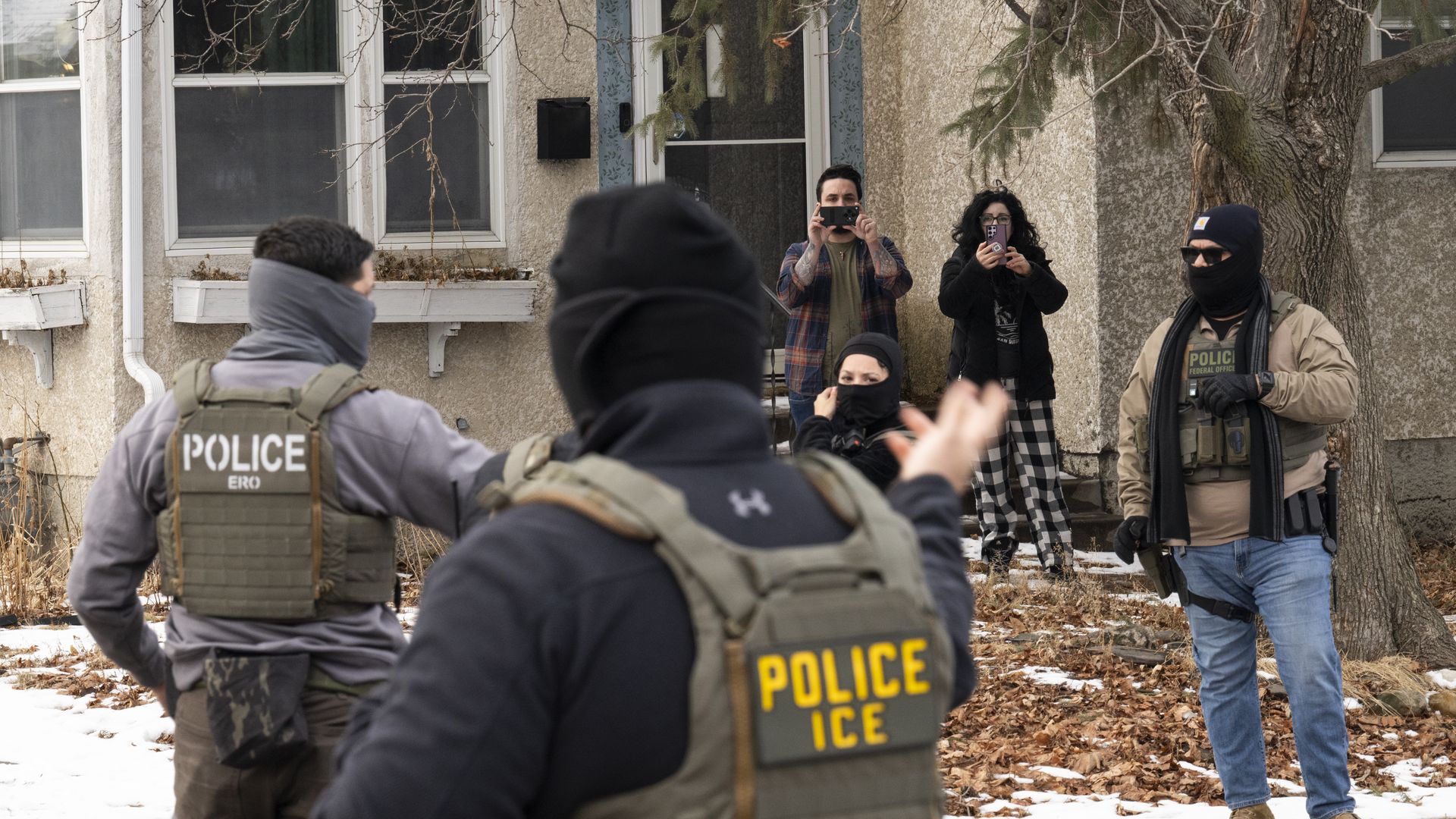  Observers film ICE agents as they hold a perimeter after one of their vehicles got a flat tire on Penn Avenue on February 5, 2026 in Minneapolis, Minnesota. Protests continue calling for an end to immigration raids in the Twin cities which have already resulted in the fatal shooting deaths of Alex 
