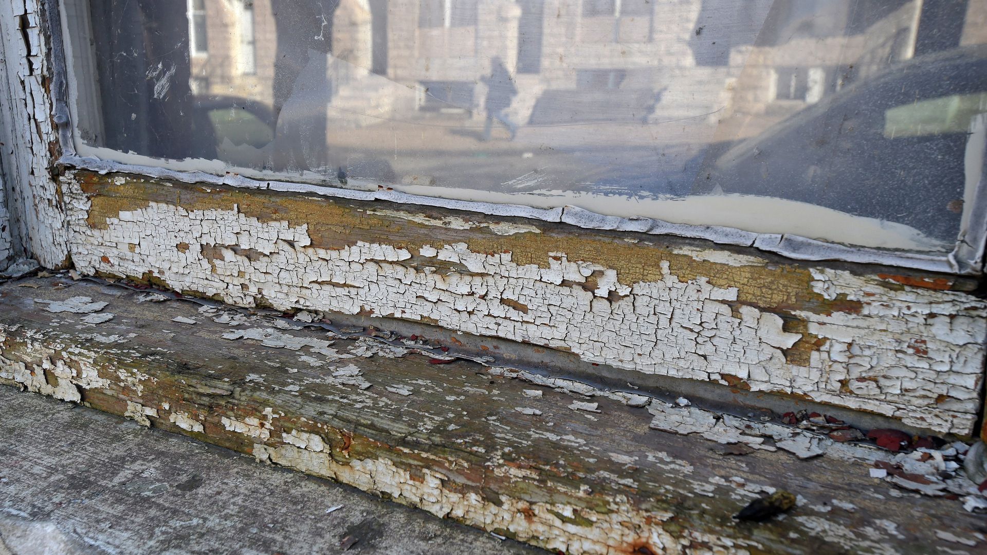 Lead paint chipping on a window sill. 