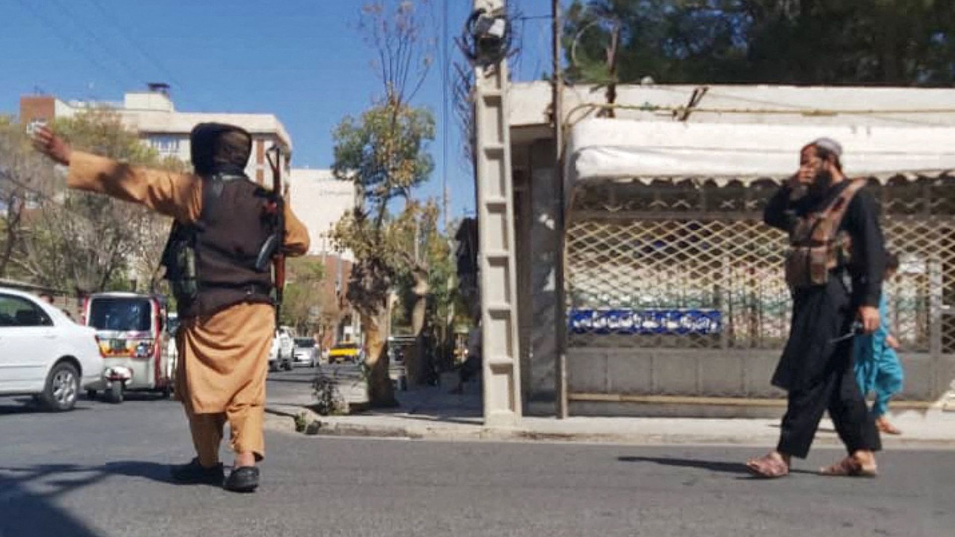 Taliban fighters block a road after a blast during the Friday prayer in Gazargah mosque, in Herat on September 2, 2022. 