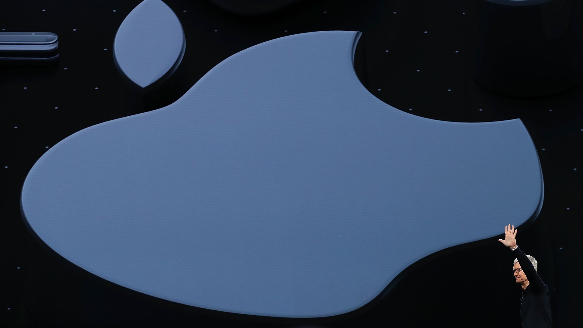 Tim Cook waves before Apple Logo.