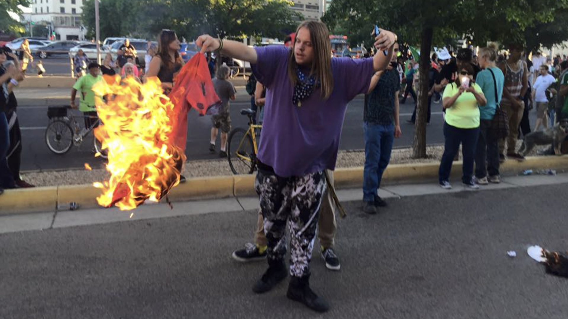 A protester burns a stolen MAGA shirt at a 2016 Donald Trump rally in Albuquerque, N.M., that turned violent.