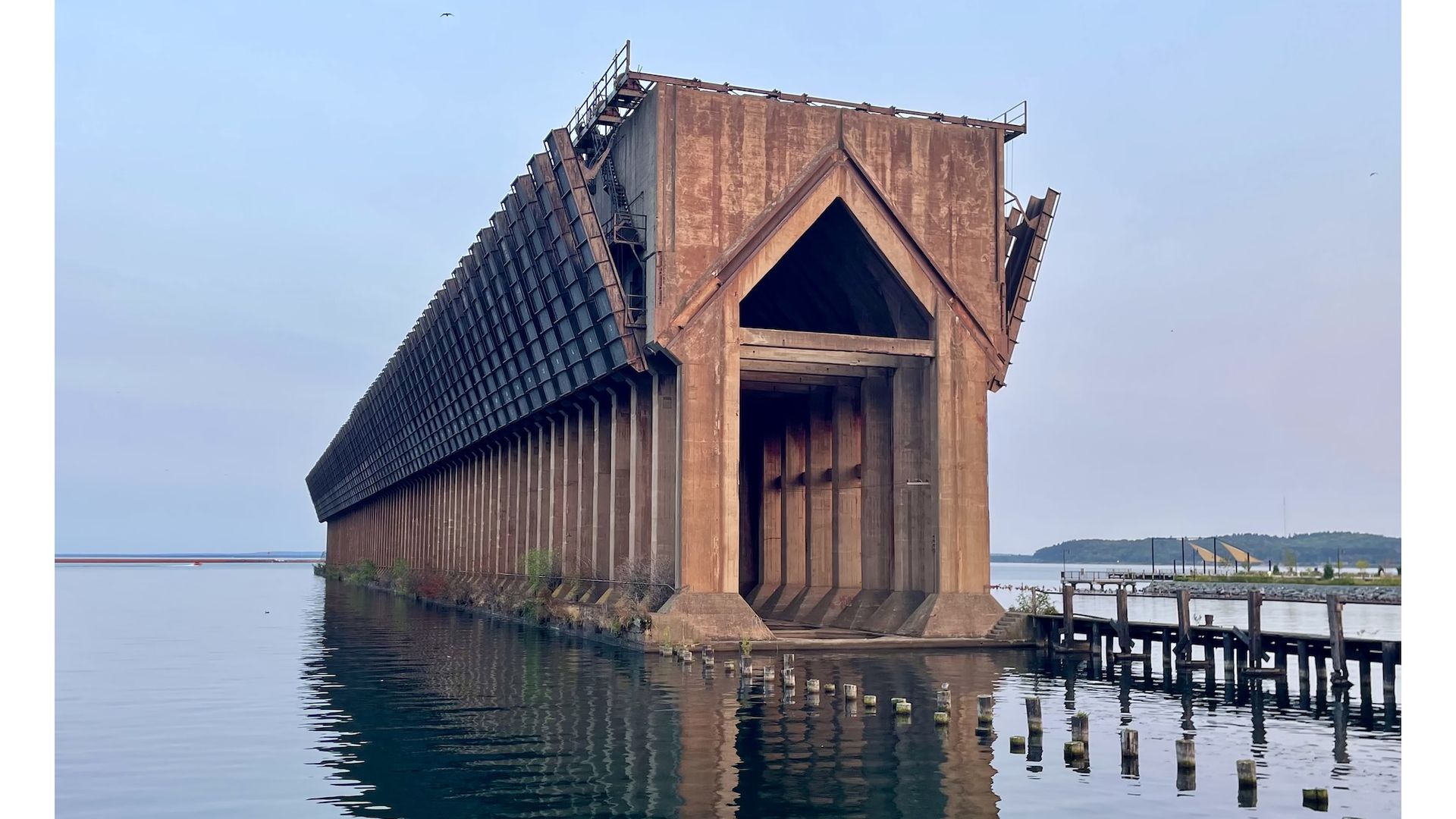 Brown metal tunnel in water.