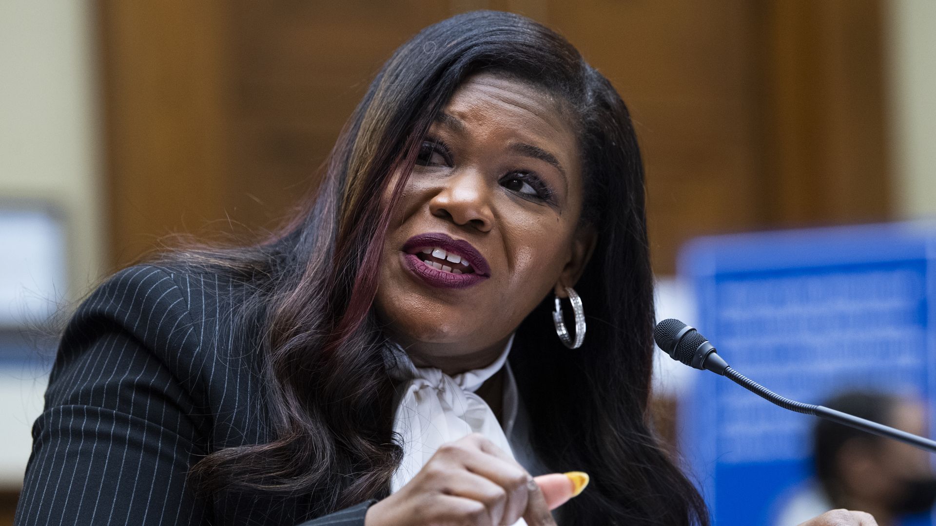 Picture of Cori Bush speaking into a microphone