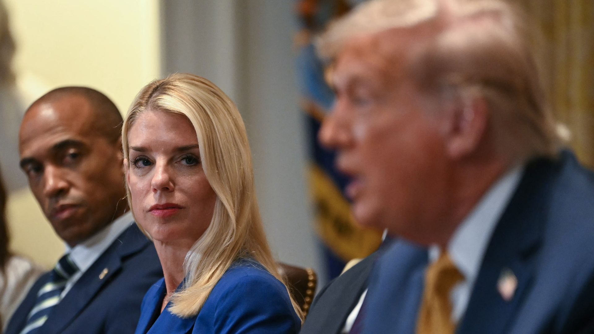 US Secretary of Housing and Urban Development Scott Turner and Attorney General Pam Bondi look on as President Donald Trump speaks during a cabinet meeting in the Cabinet Room of the White House in Washington, DC, on July 8, 2025.