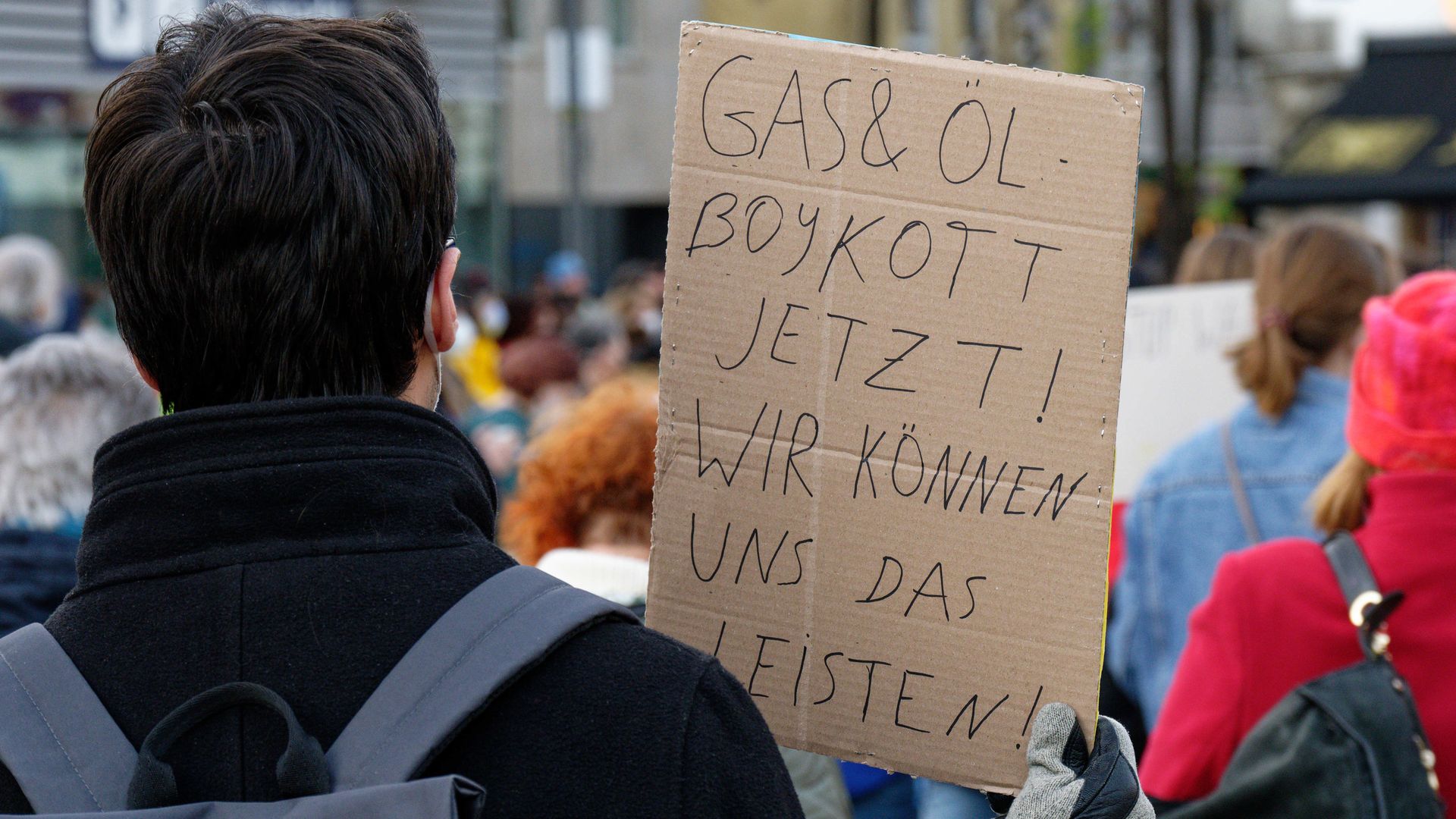 Germans are seen calling for a Russian oil and gas boycott in protest of the Ukraine invasion.