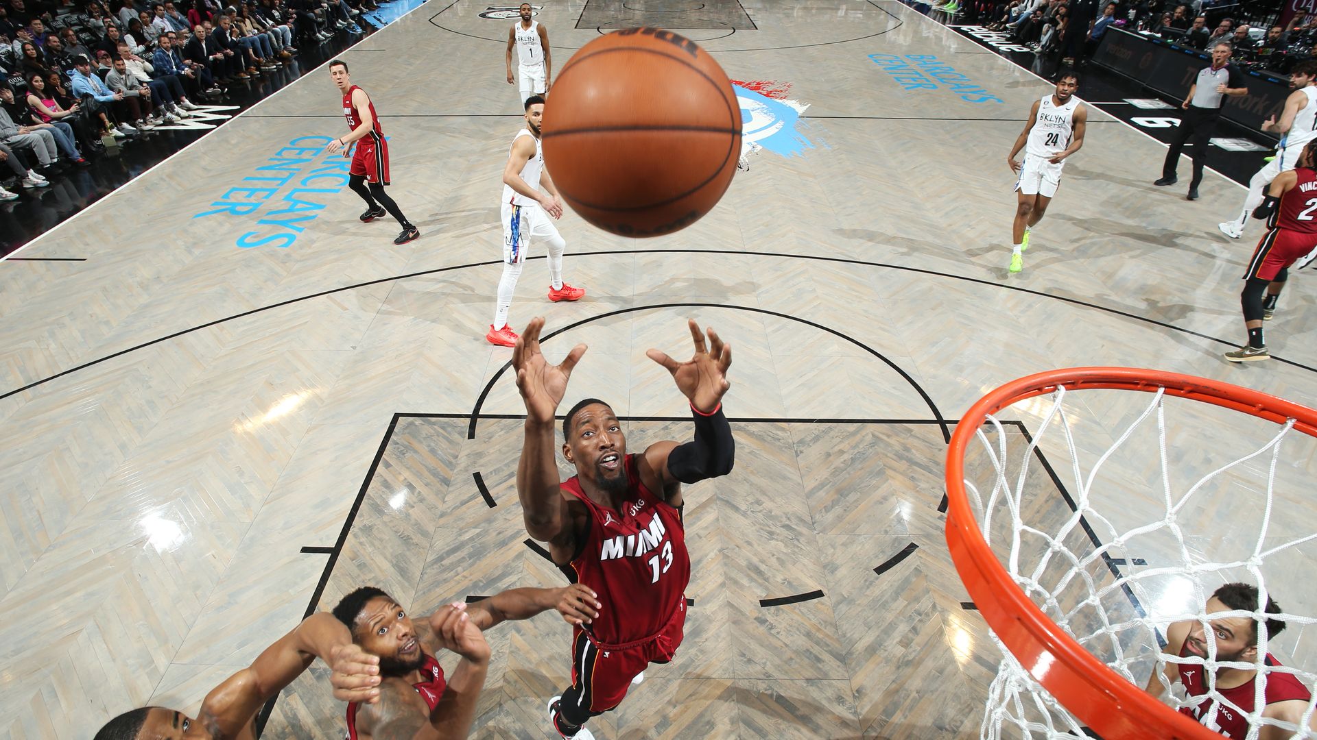 Miami Heat center Bam Adebayo jumps to grab a rebound.