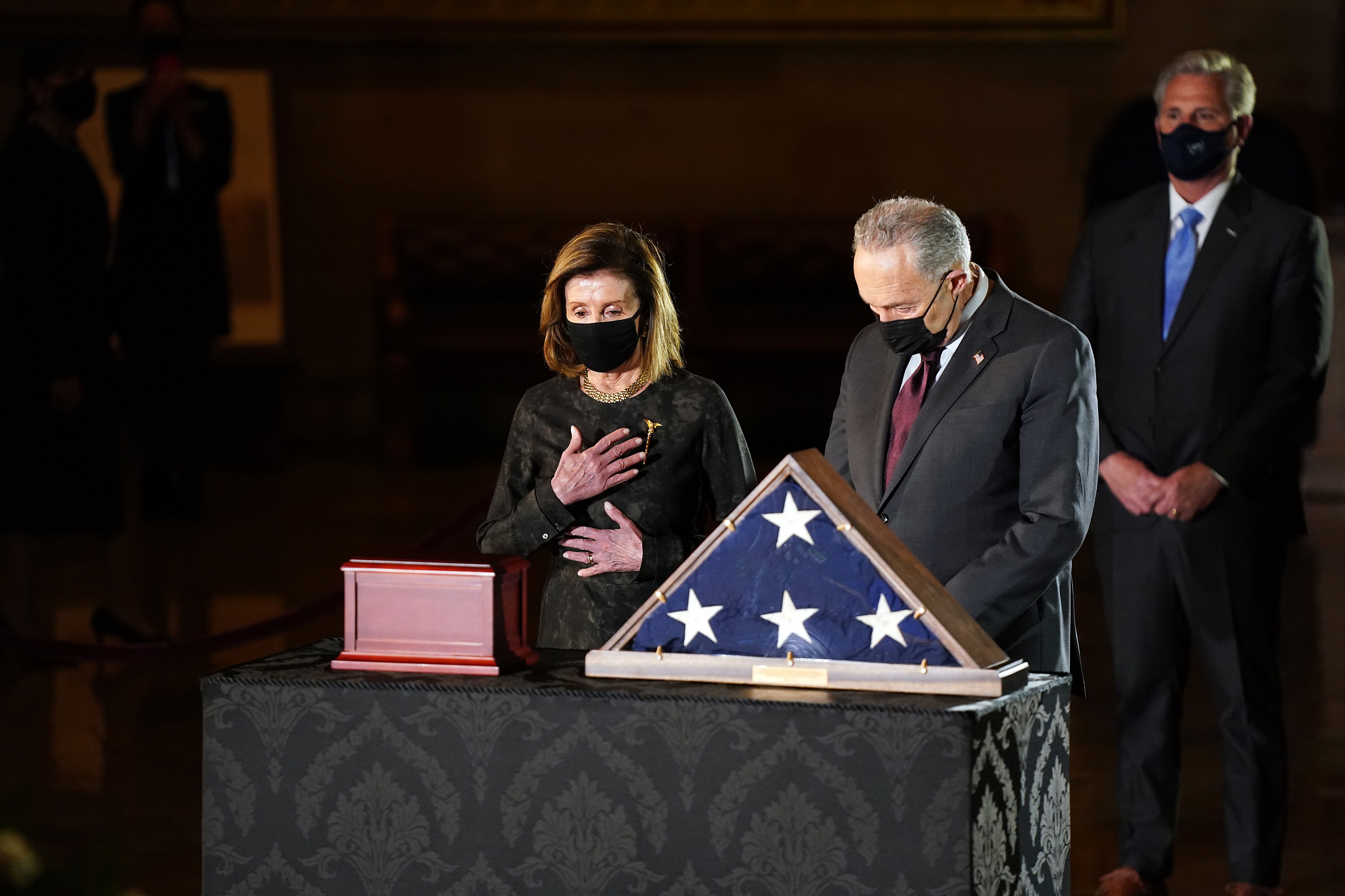 Speaker Nancy Pelosi and Senate Majority Leader Chuck Schumer pay their respects in front of the remains of U.S. Capitol Police Officer Brian Sicknick in the Rotunda