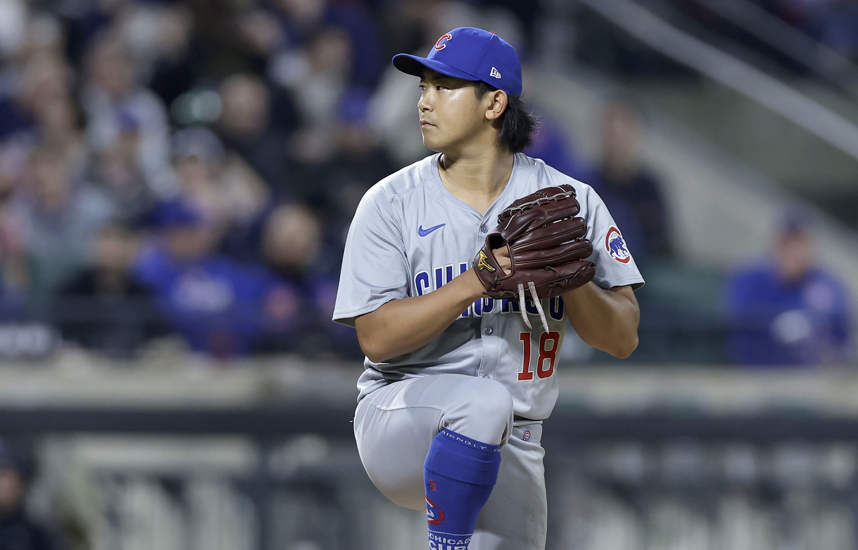 Photo of a baseball pitcher getting ready to throw to the batter 