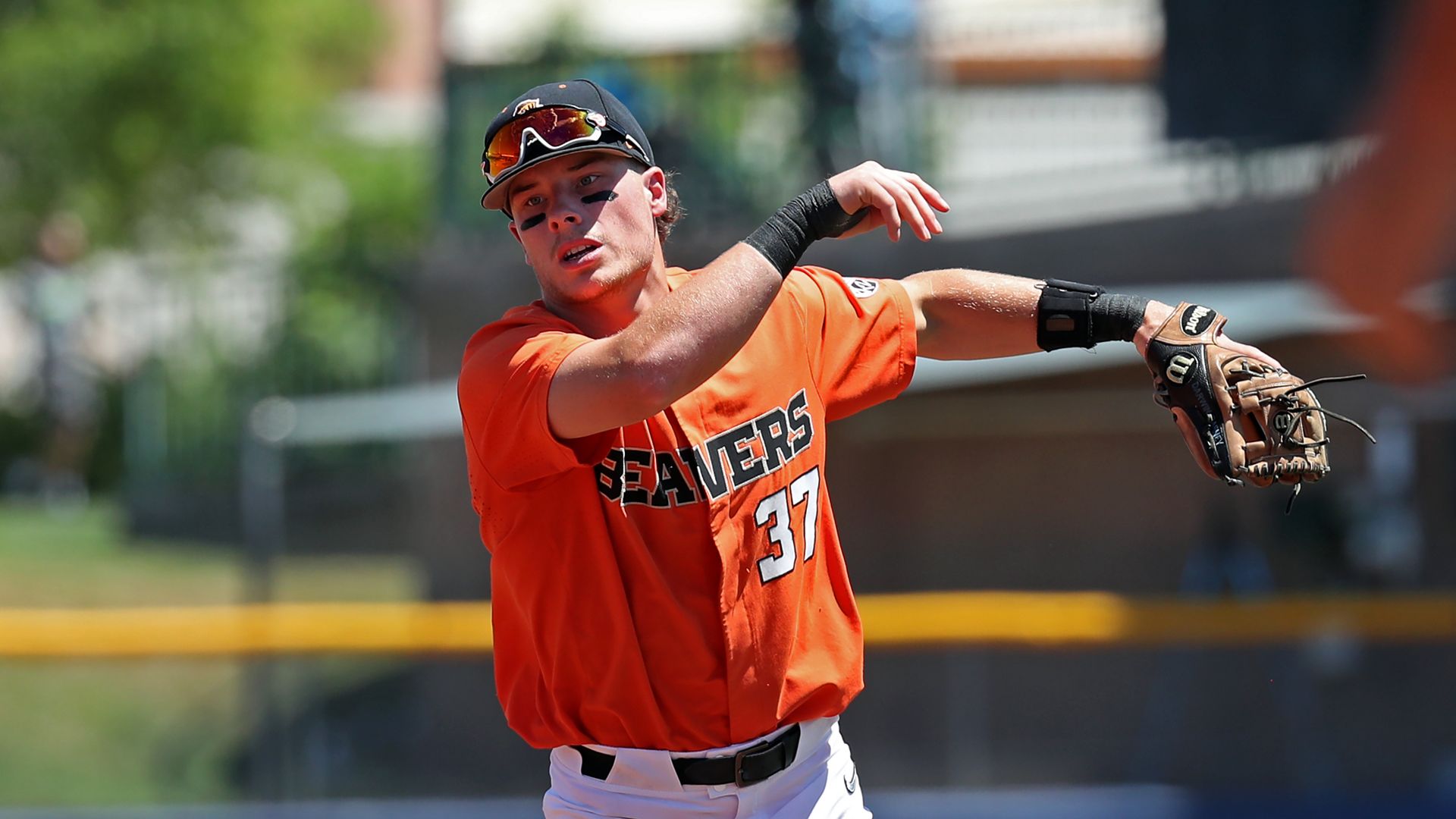A Oregon State Beavers player throws a baseball from the infield.